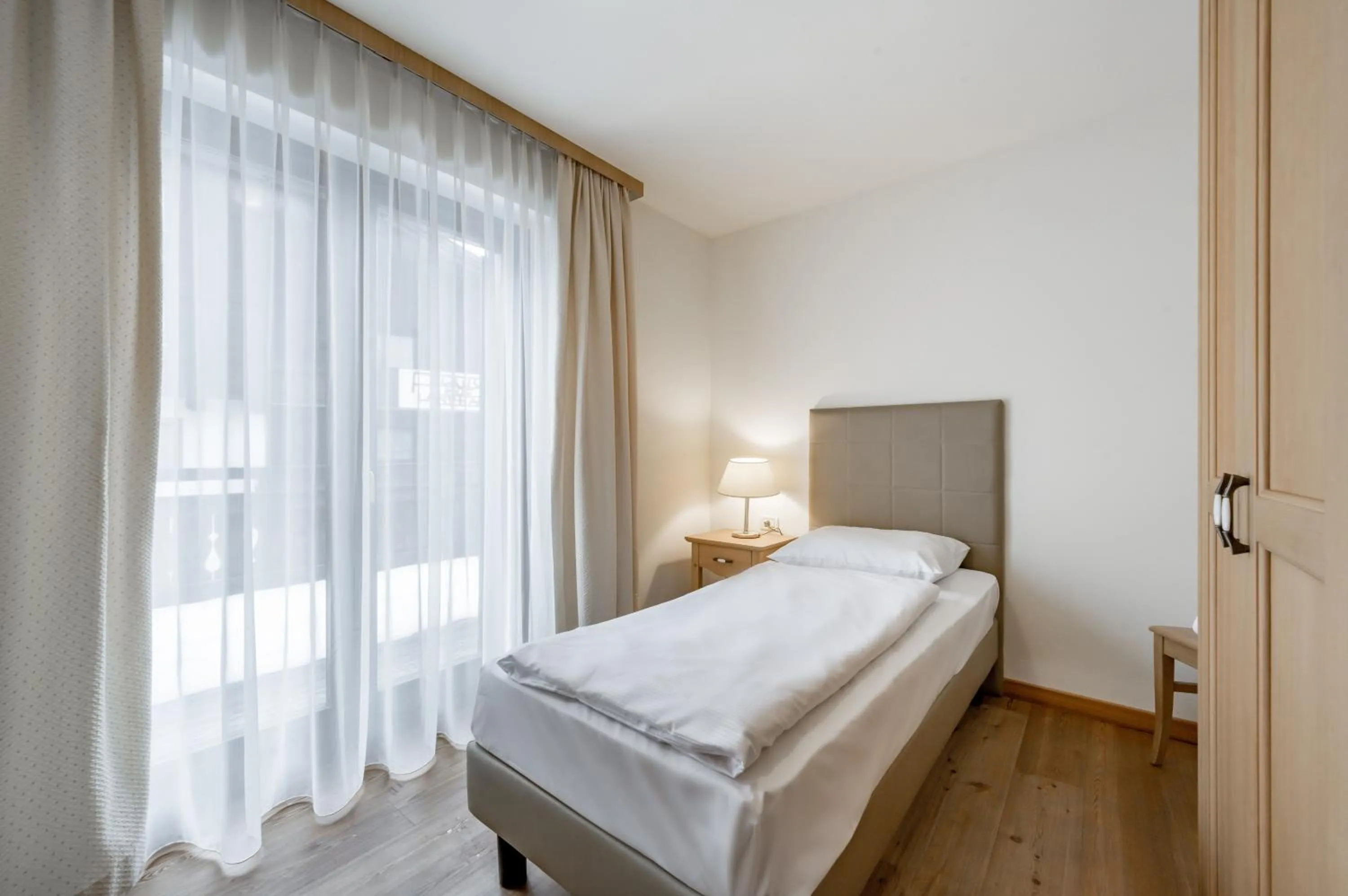 Bed in Apartment Torri di Seefeld