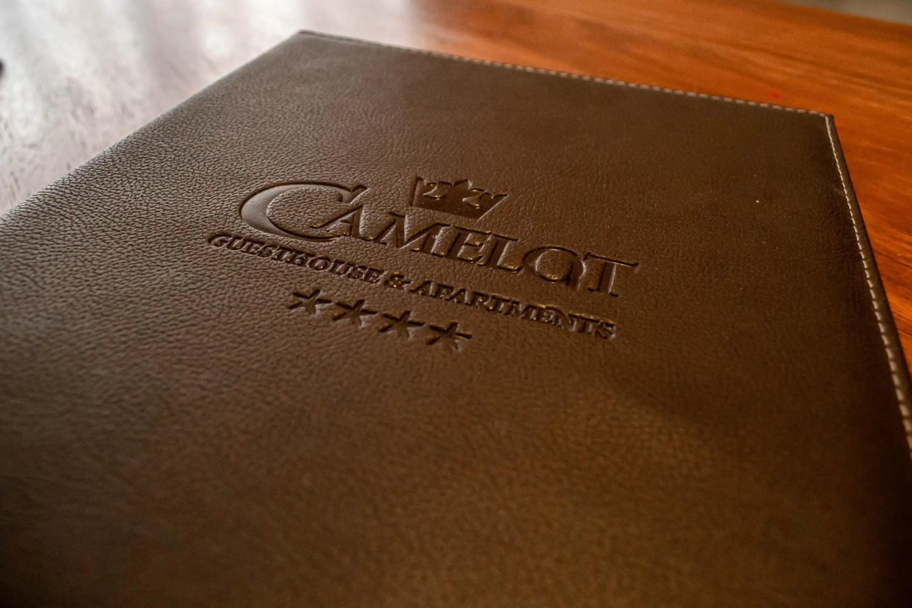 Property logo or sign in Camelot Guest House & Apartments