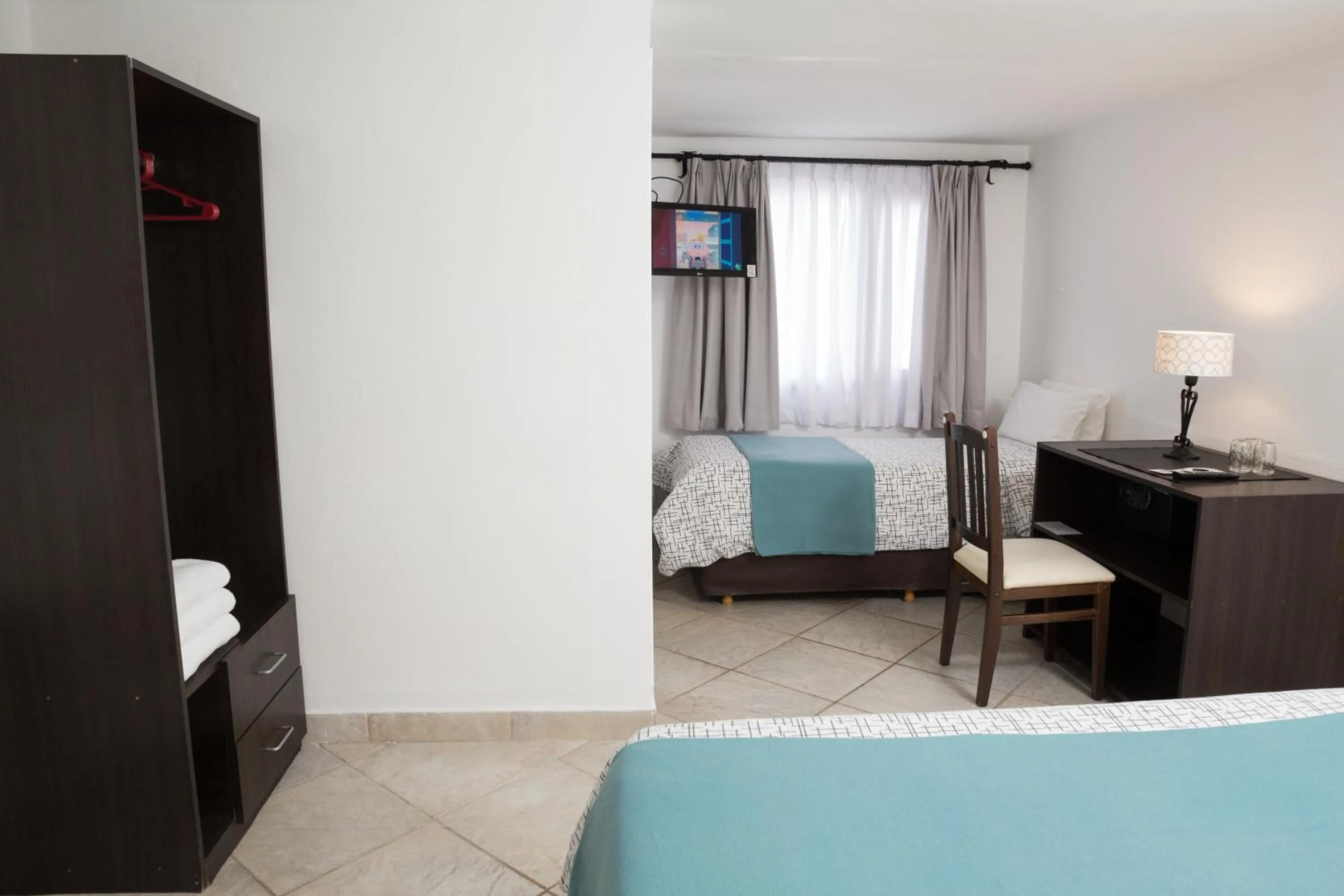 Bed in NBH Premier Hotel