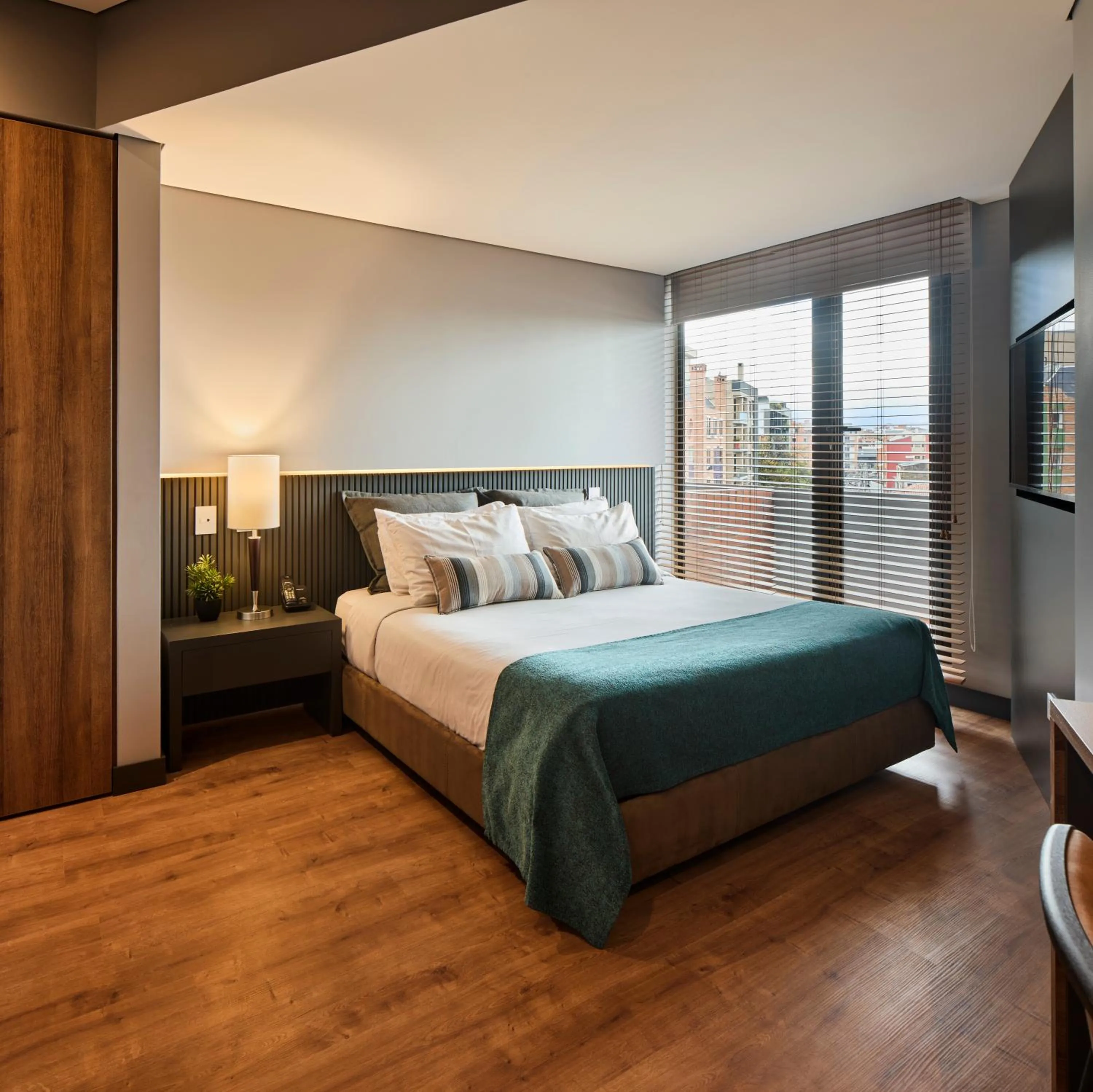 Bed in Nico Apartasuites