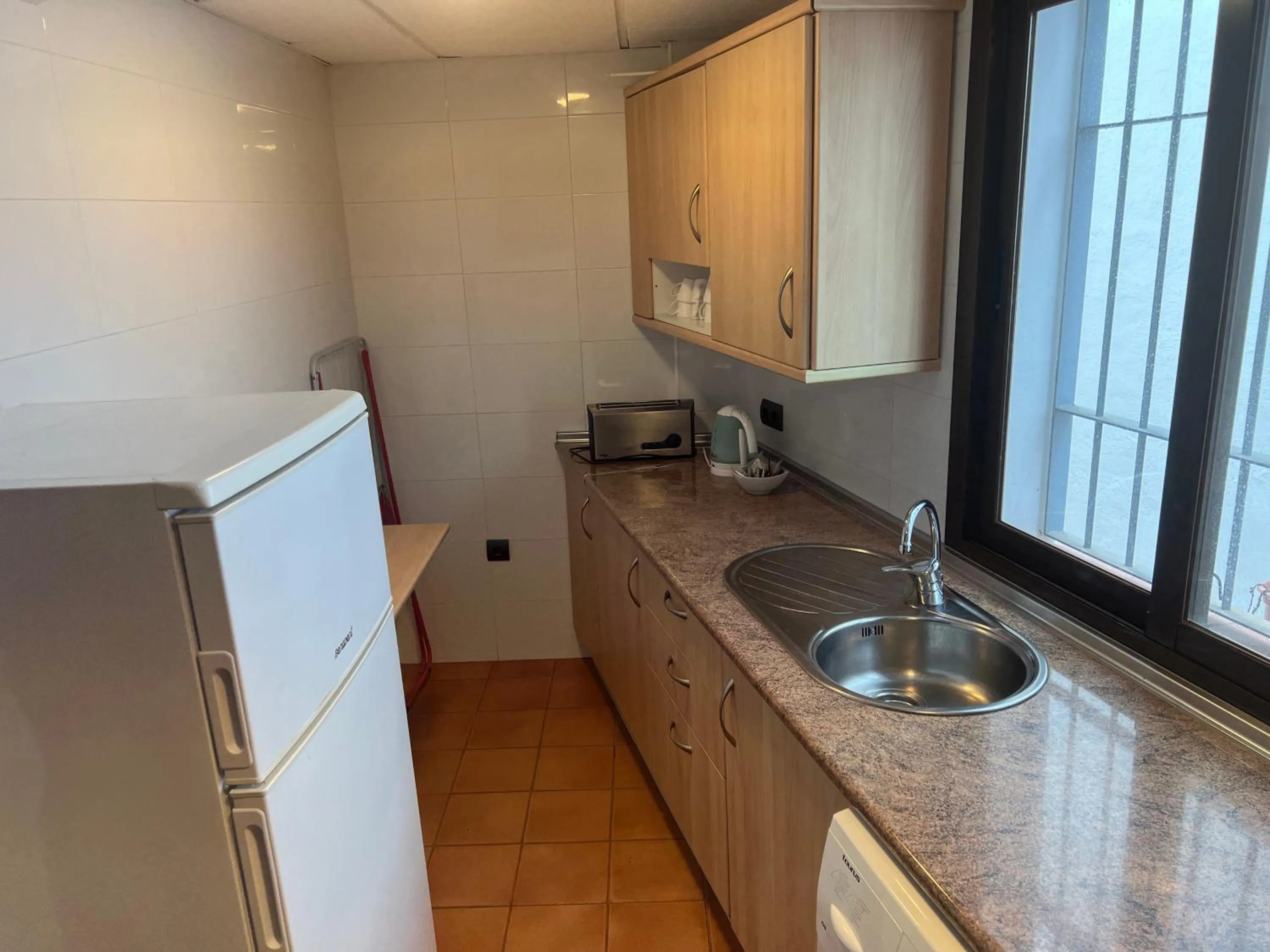 Kitchen or kitchenette in I AM La Posada Hotel and Apartment