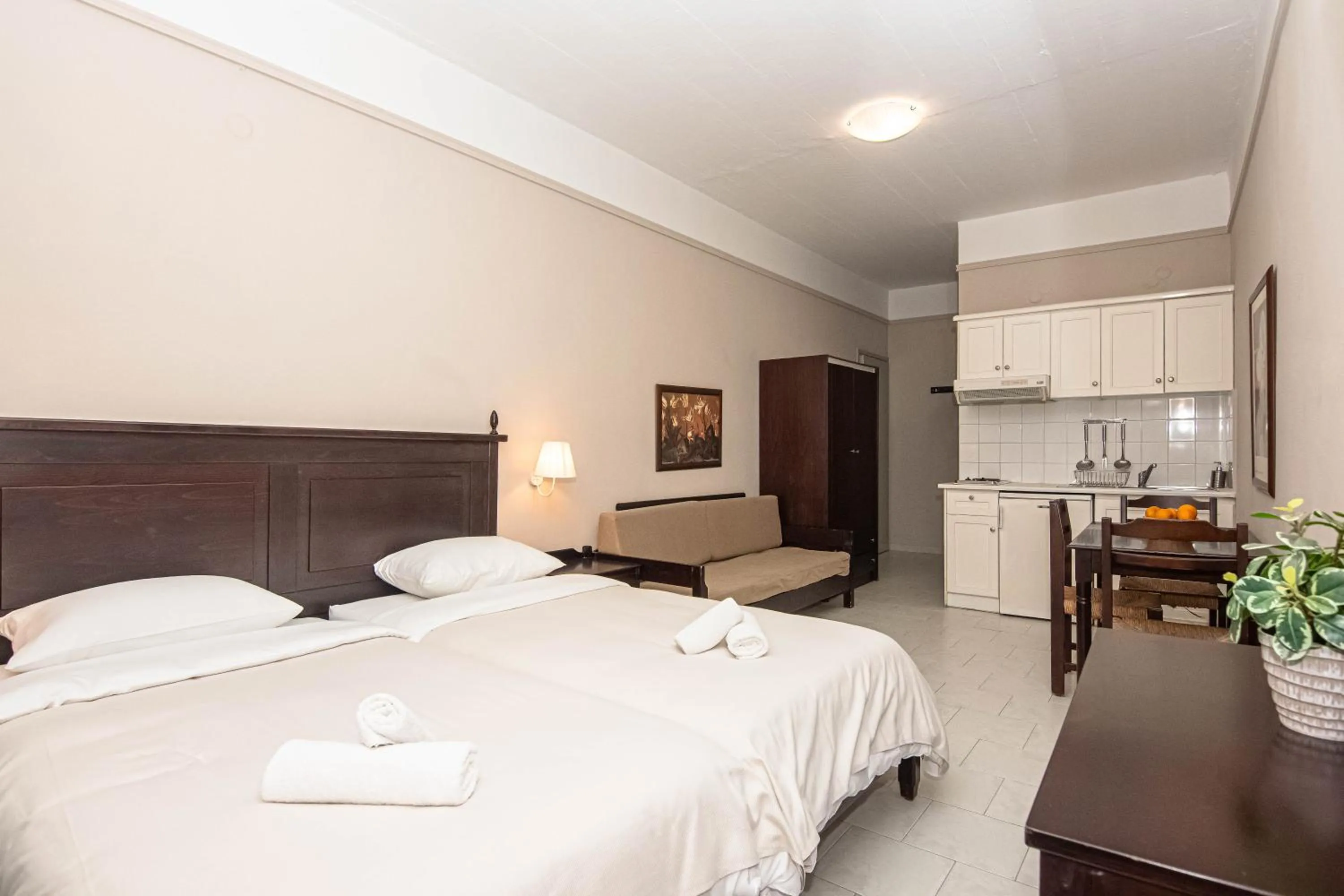 Bed in Talos Hotel Apartments