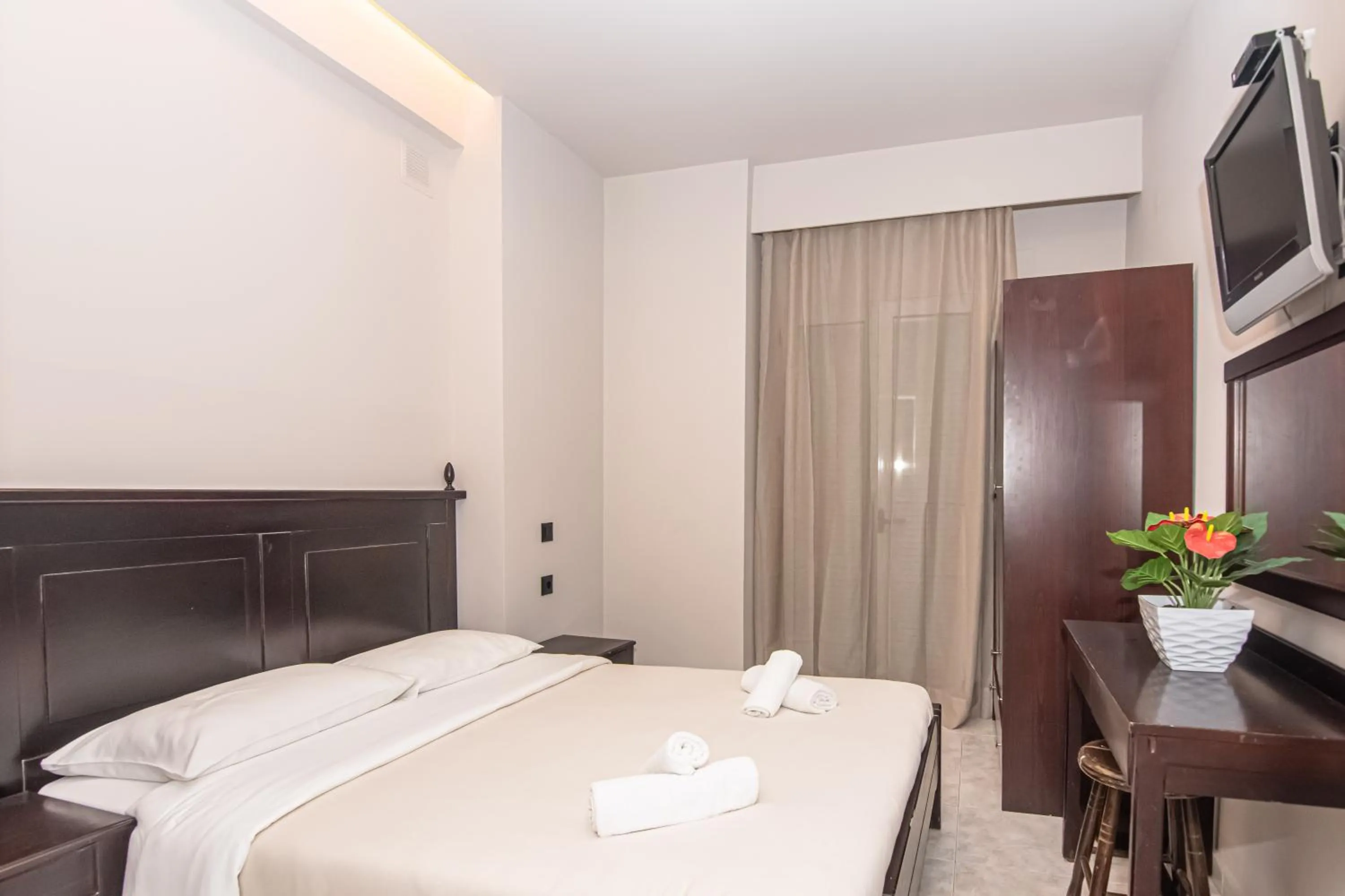 Bed in Talos Hotel Apartments