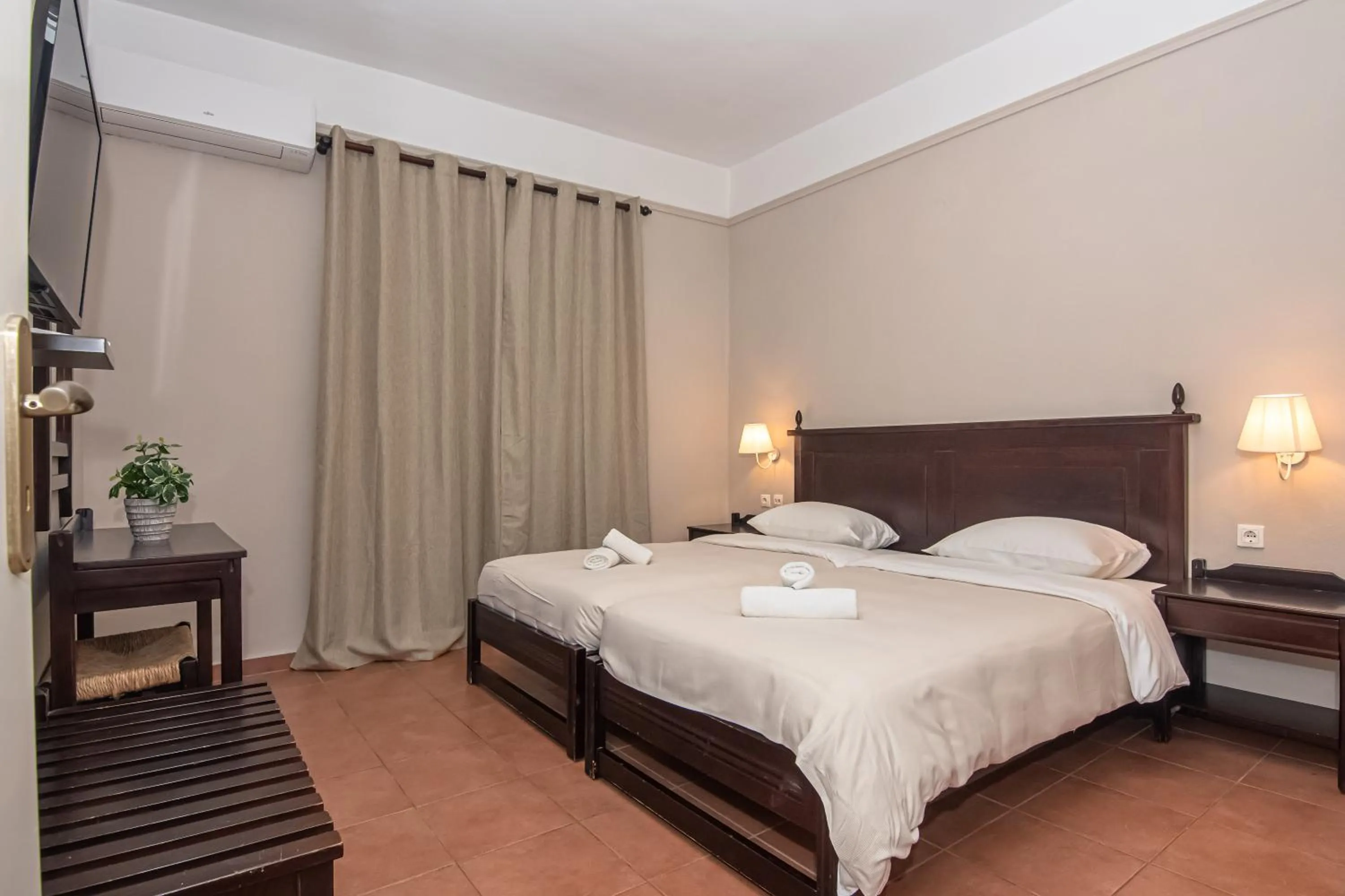 Bed in Talos Hotel Apartments