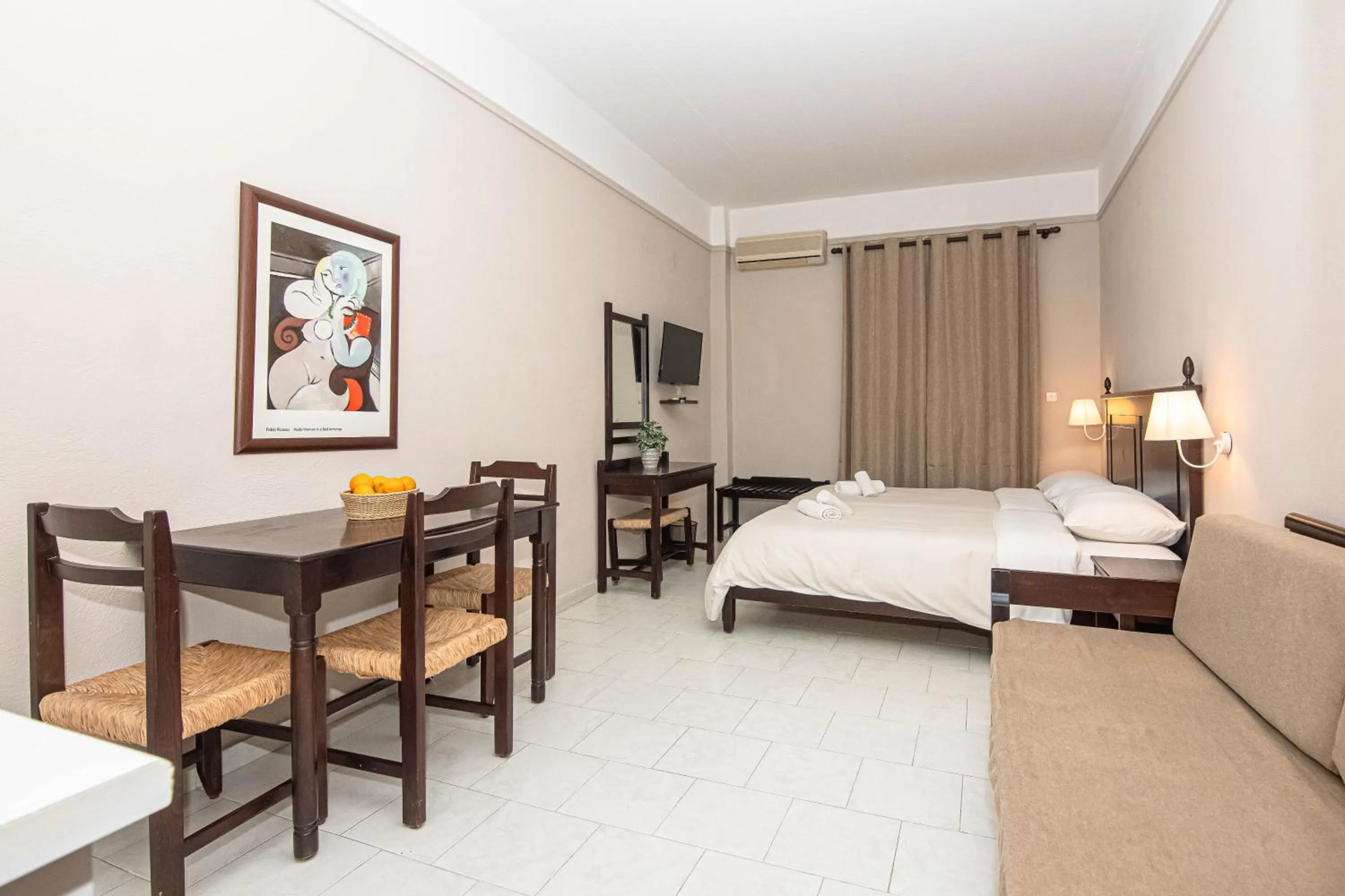 Bed in Talos Hotel Apartments