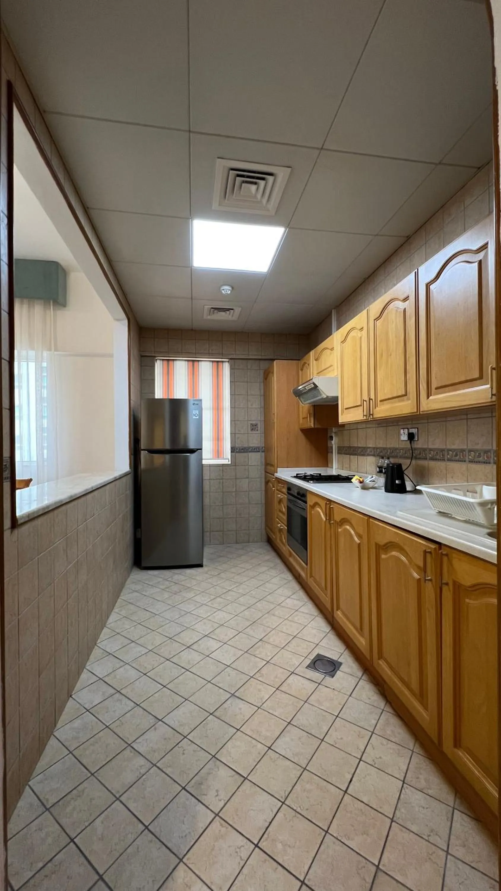 Kitchen or kitchenette in Uptown Hotel Apartments Abu Dhabi by Gewan