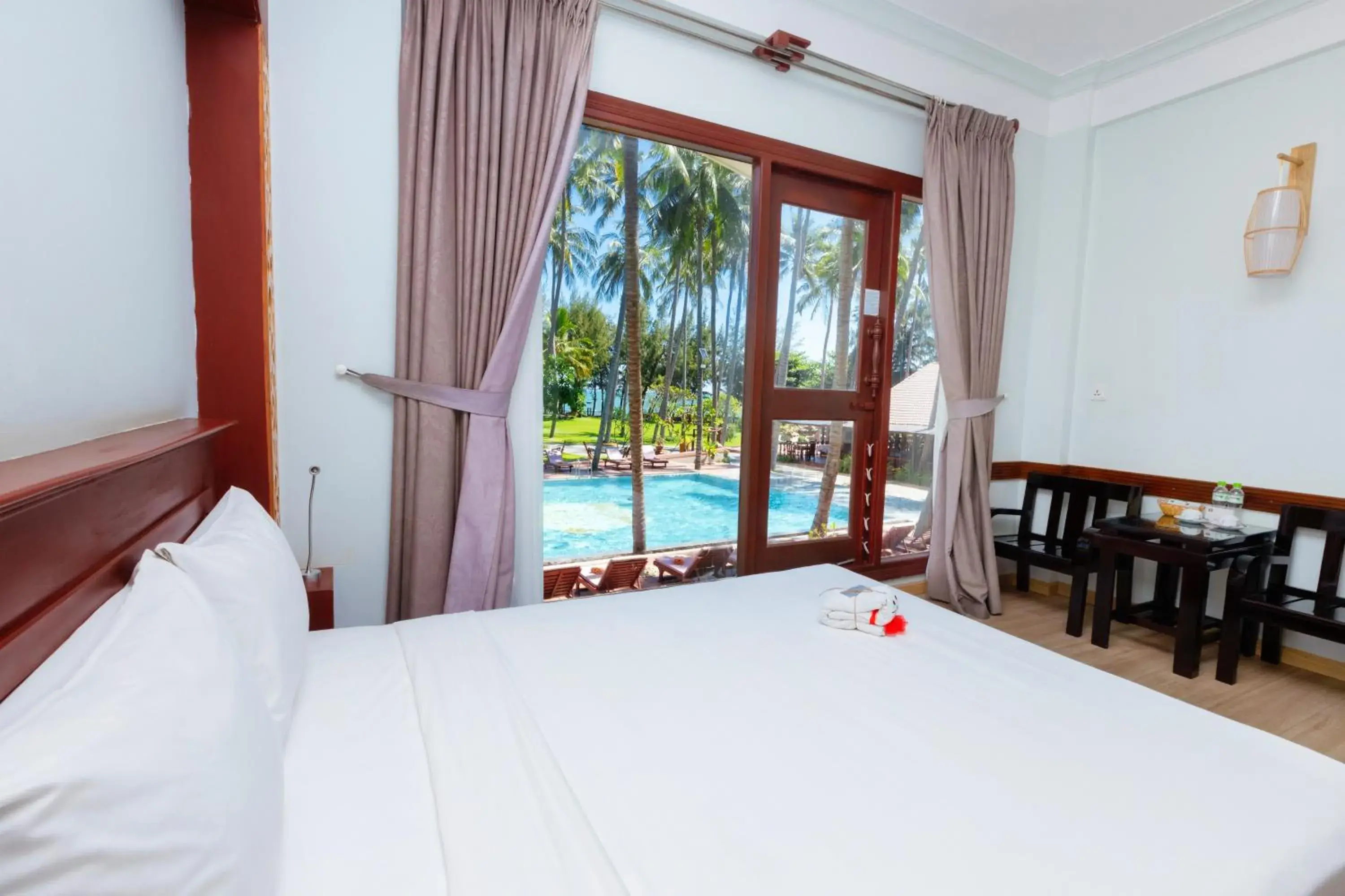 Pool view, Bed in Ca Ty Mui ne Beach Resort & Spa Pool view, Bed in Ca Ty Mui ne Beach Resort & Spa