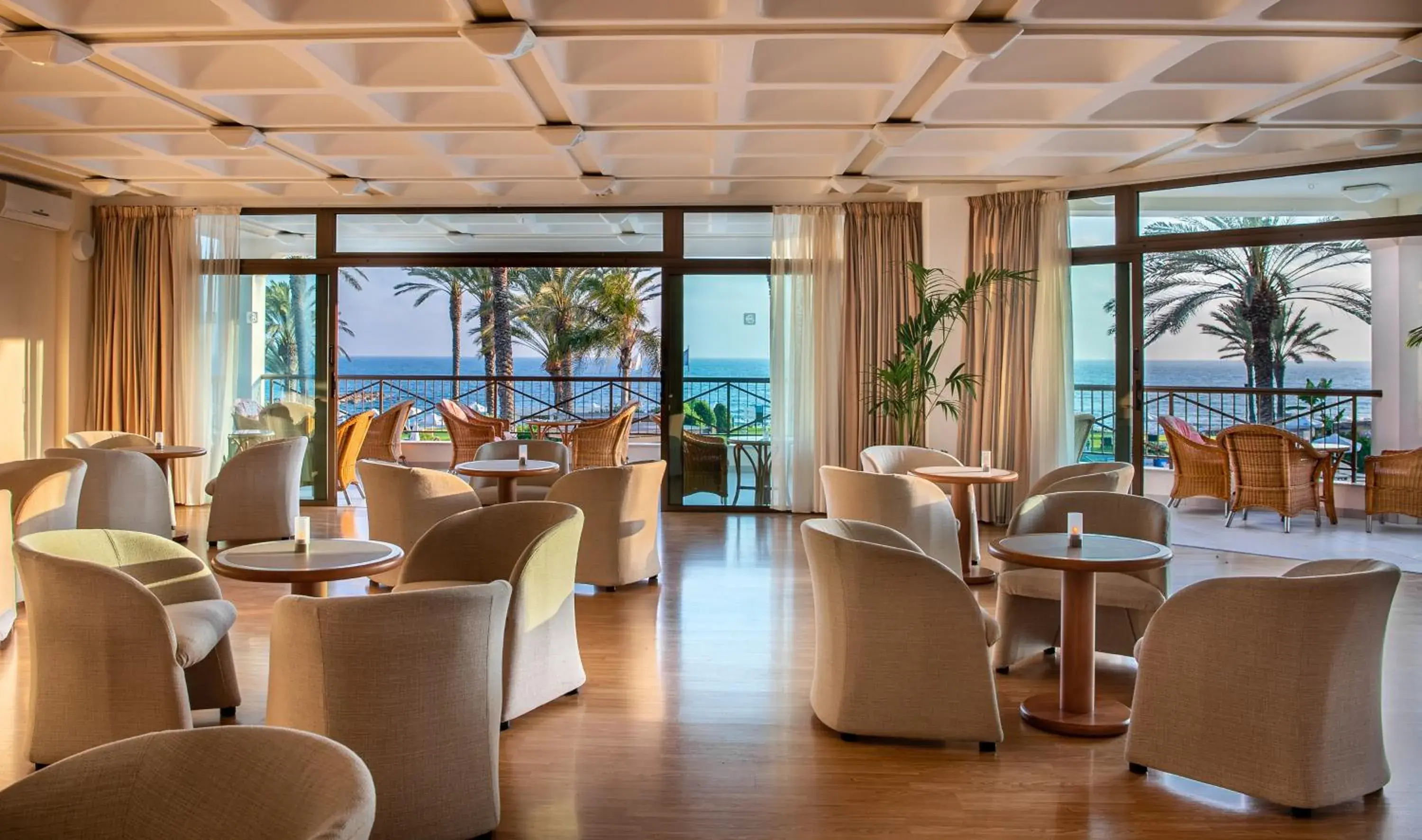 Lounge or bar in Constantinou Bros Athena Beach Hotel Lounge or bar in Constantinou Bros Athena Beach Hotel