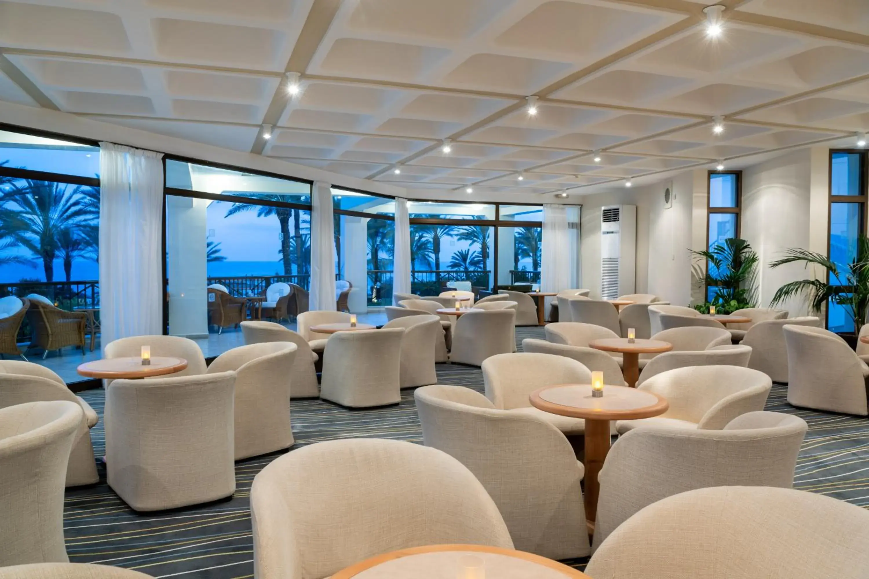 Lounge or bar in Constantinou Bros Athena Beach Hotel Lounge or bar in Constantinou Bros Athena Beach Hotel
