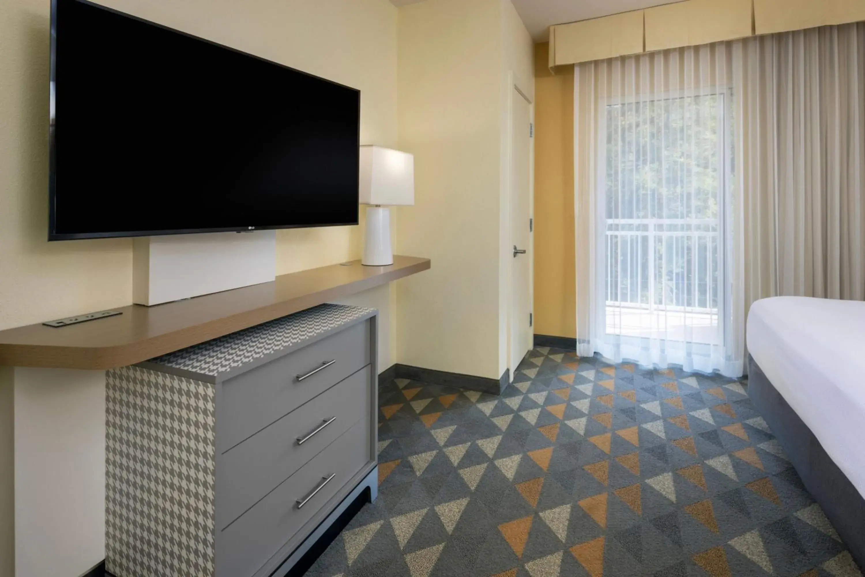Bedroom, TV/Entertainment Center in Holiday Inn & Suites Asheville-Biltmore Vlg Area, an IHG Hotel