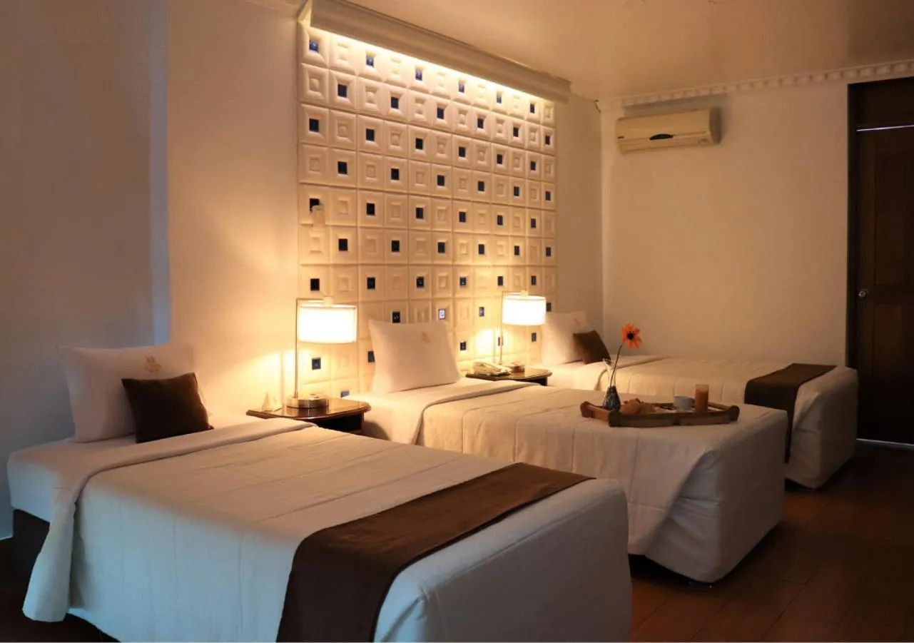 Bed in Inkari Suites Hotel