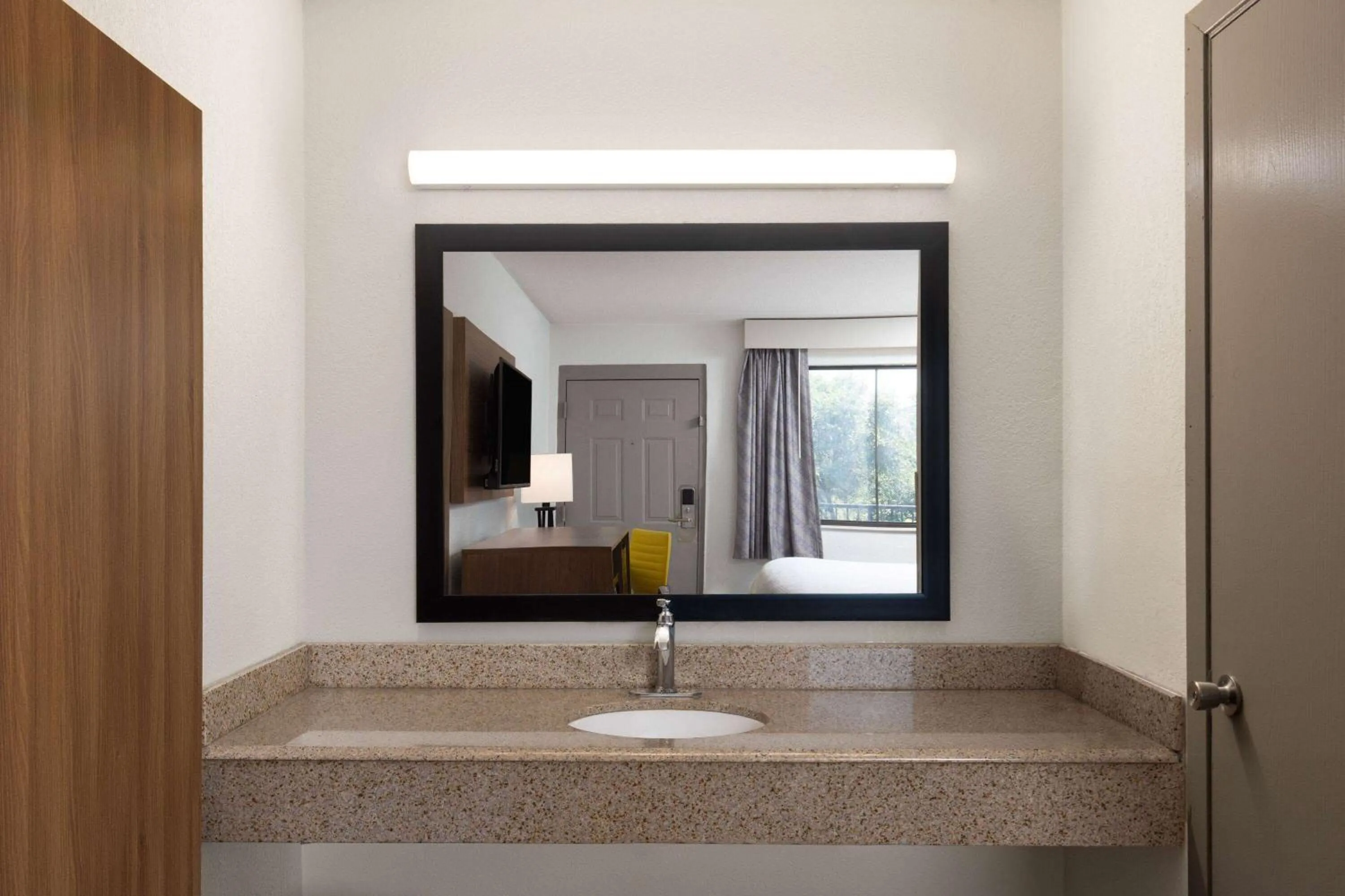 Bathroom in Day's Inn & Suites by Wyndham Indianapolis Airport East