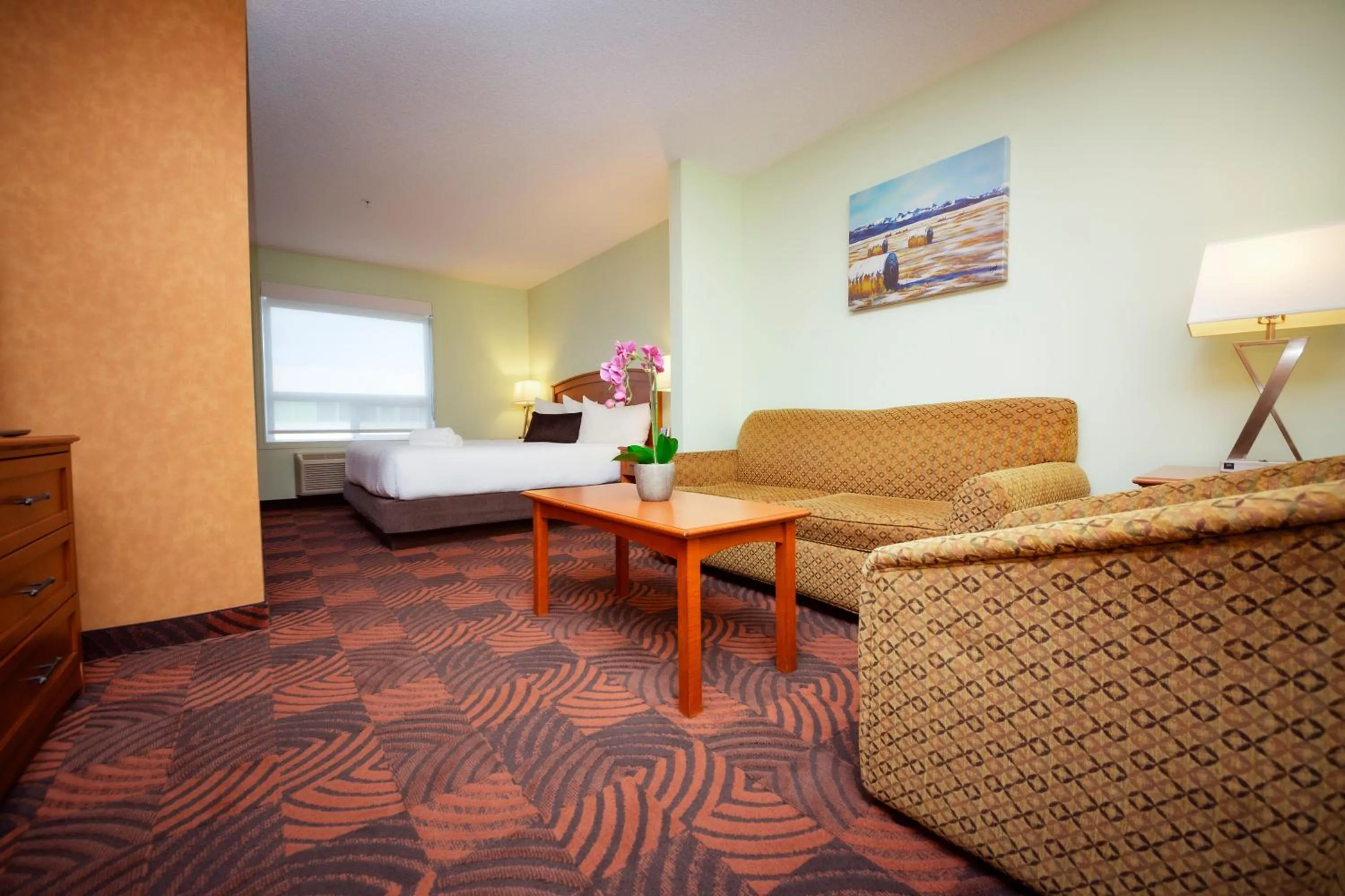 Living room, Bed in Service Plus Inns and Suites Calgary