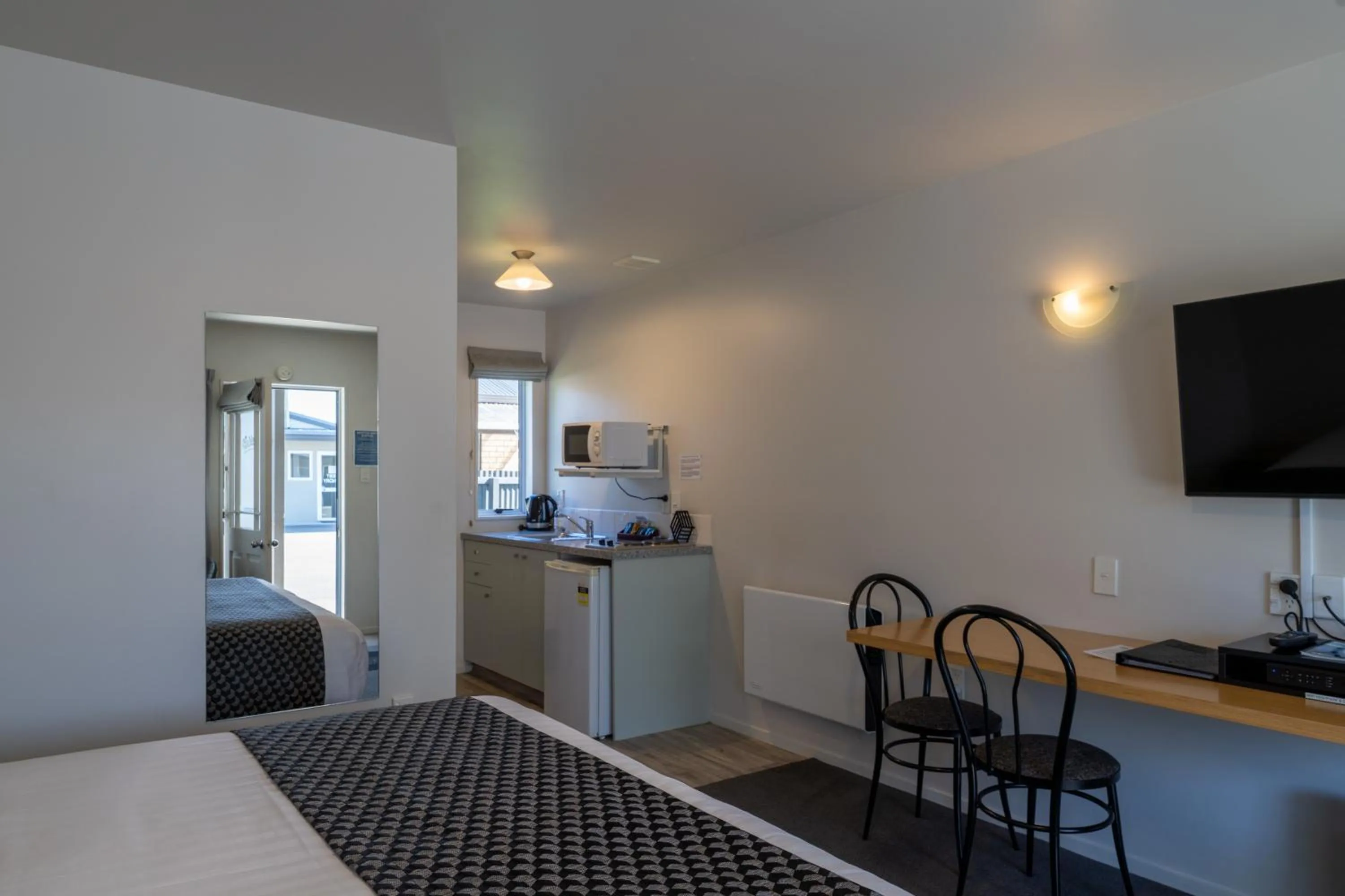 Bed in ASURE Gables Motor Lodge