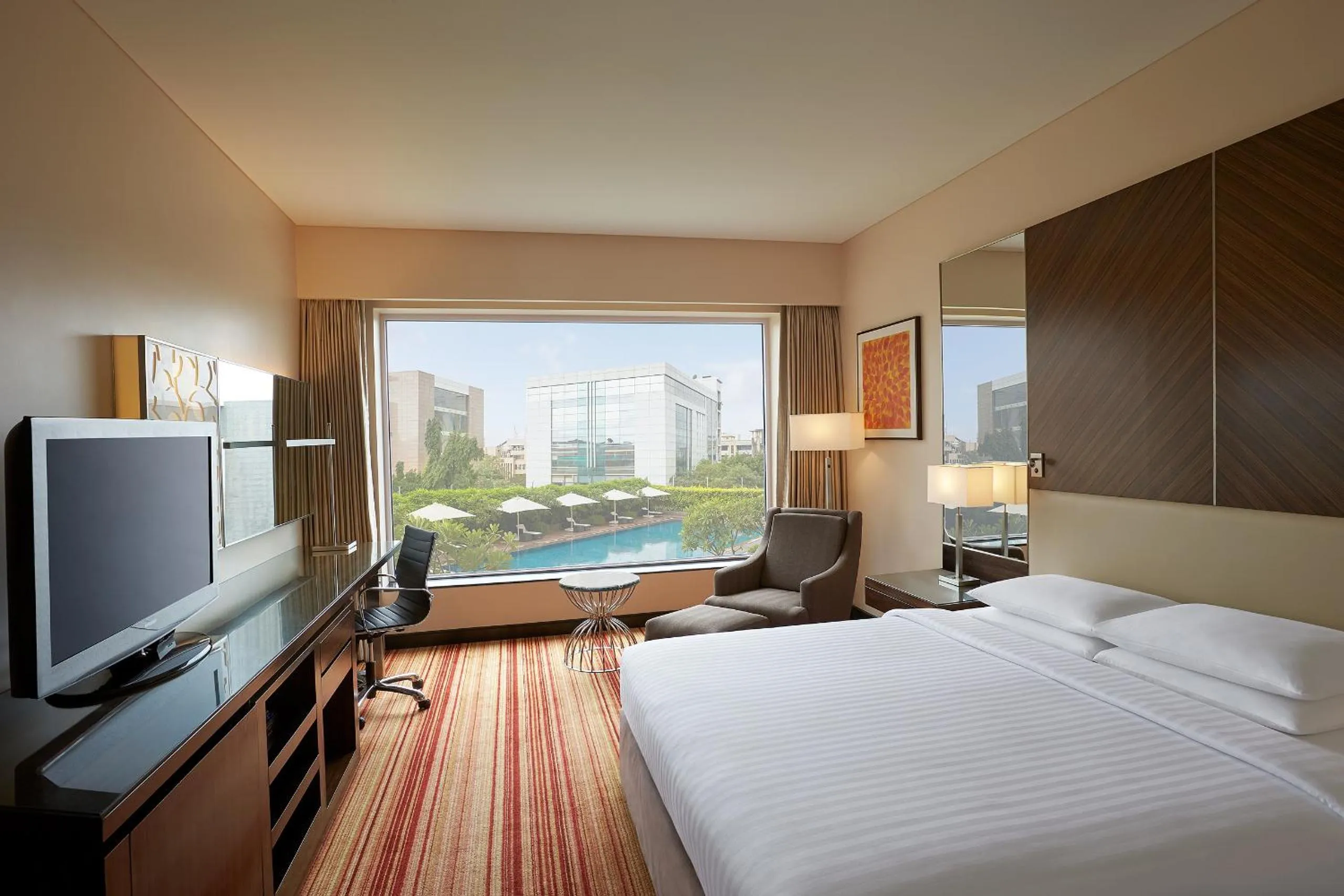 Pool view, Bed in Courtyard by Marriott Mumbai International Airport