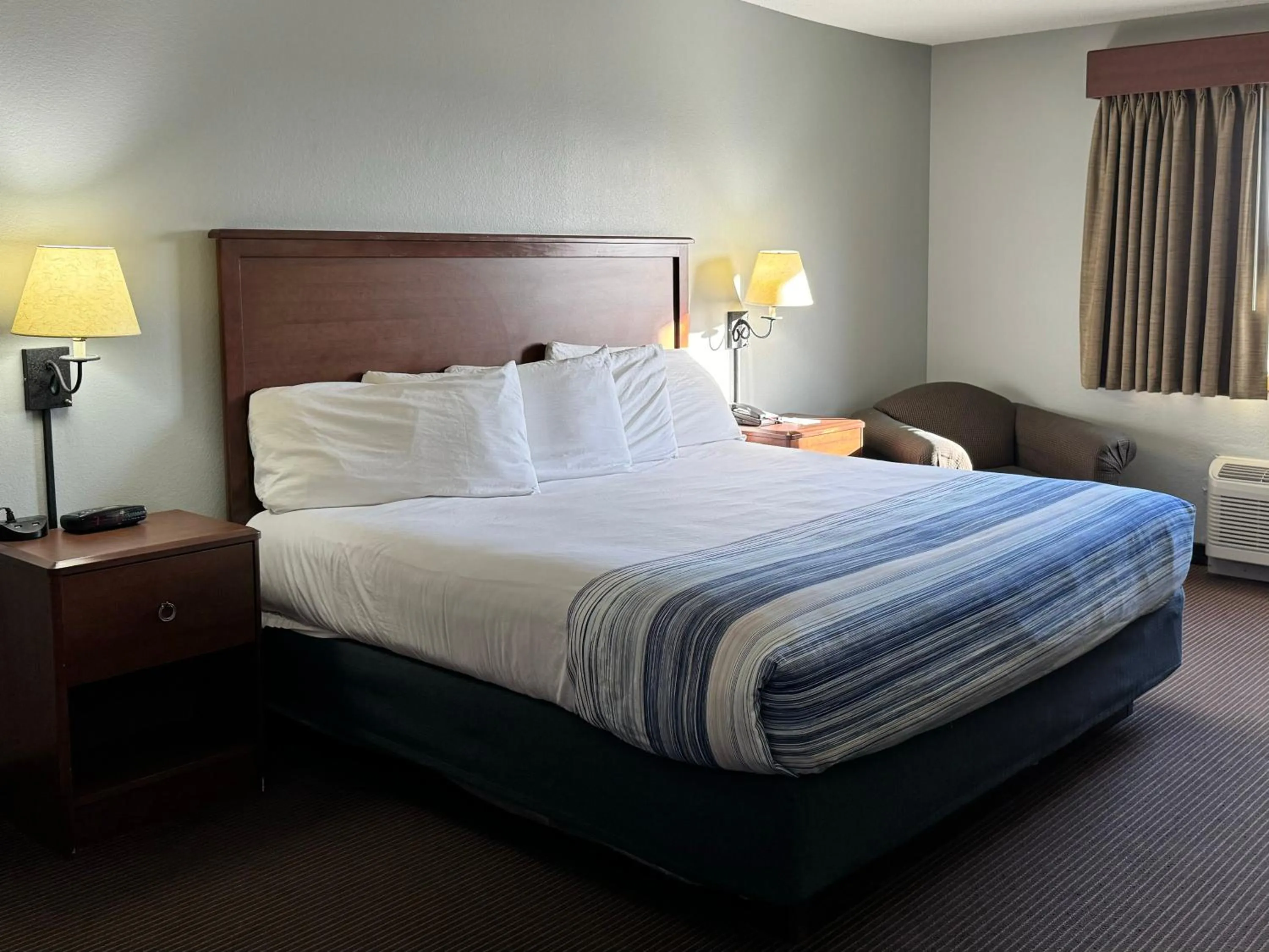 Bed in AmericInn by Wyndham Stillwater