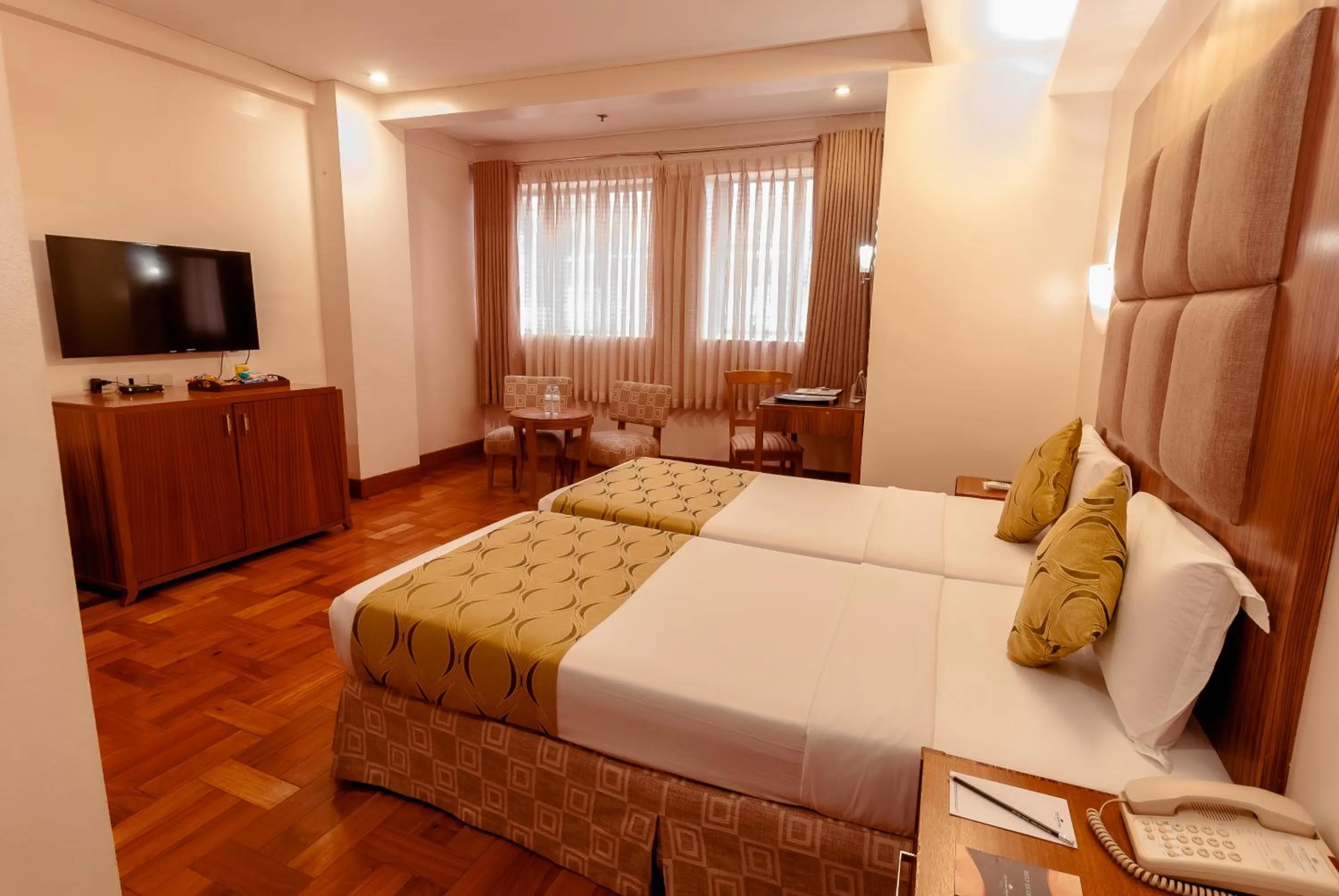 Communal lounge/ TV room, Bed in City Garden Suites Manila