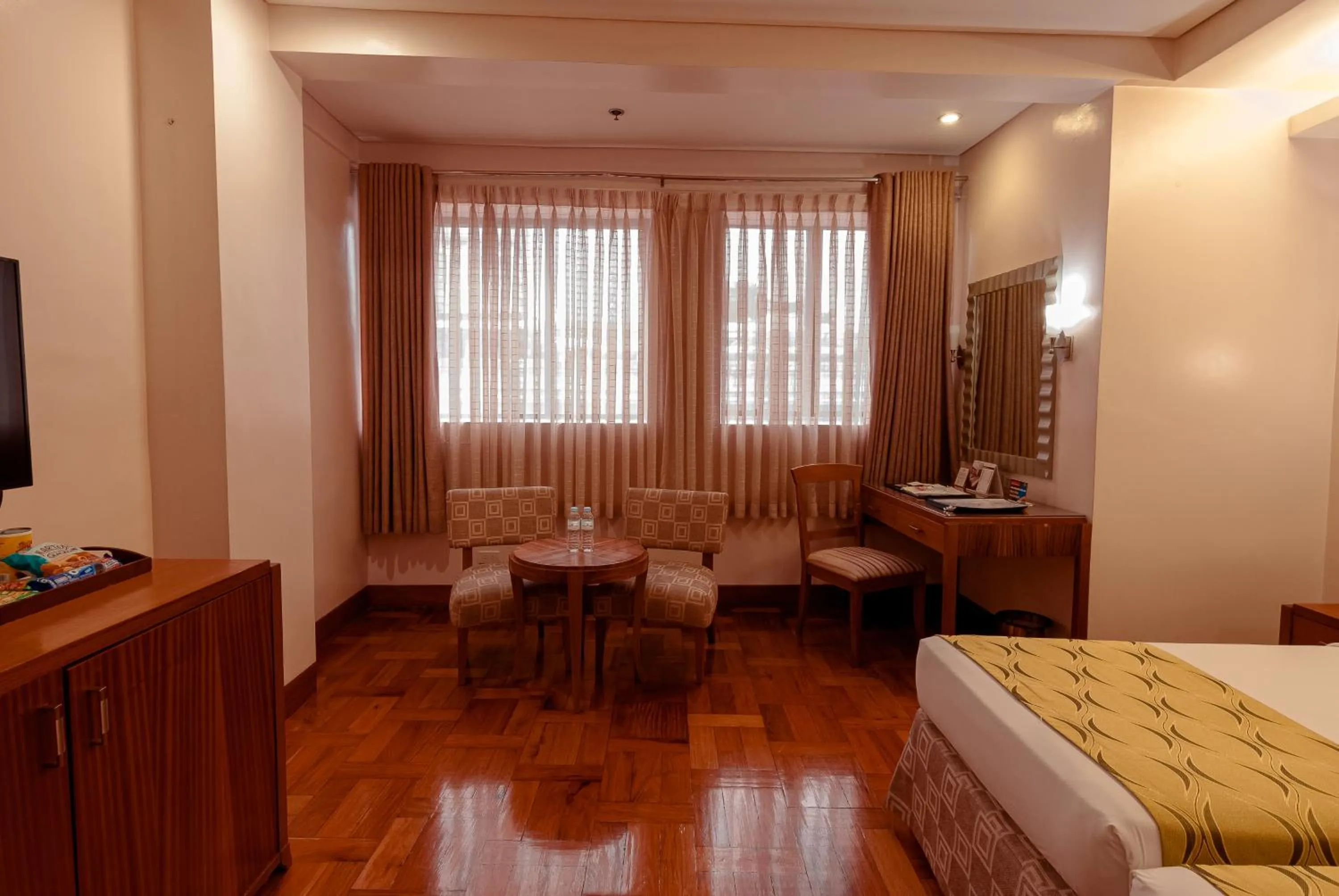 Seating area, Bed in City Garden Suites Manila