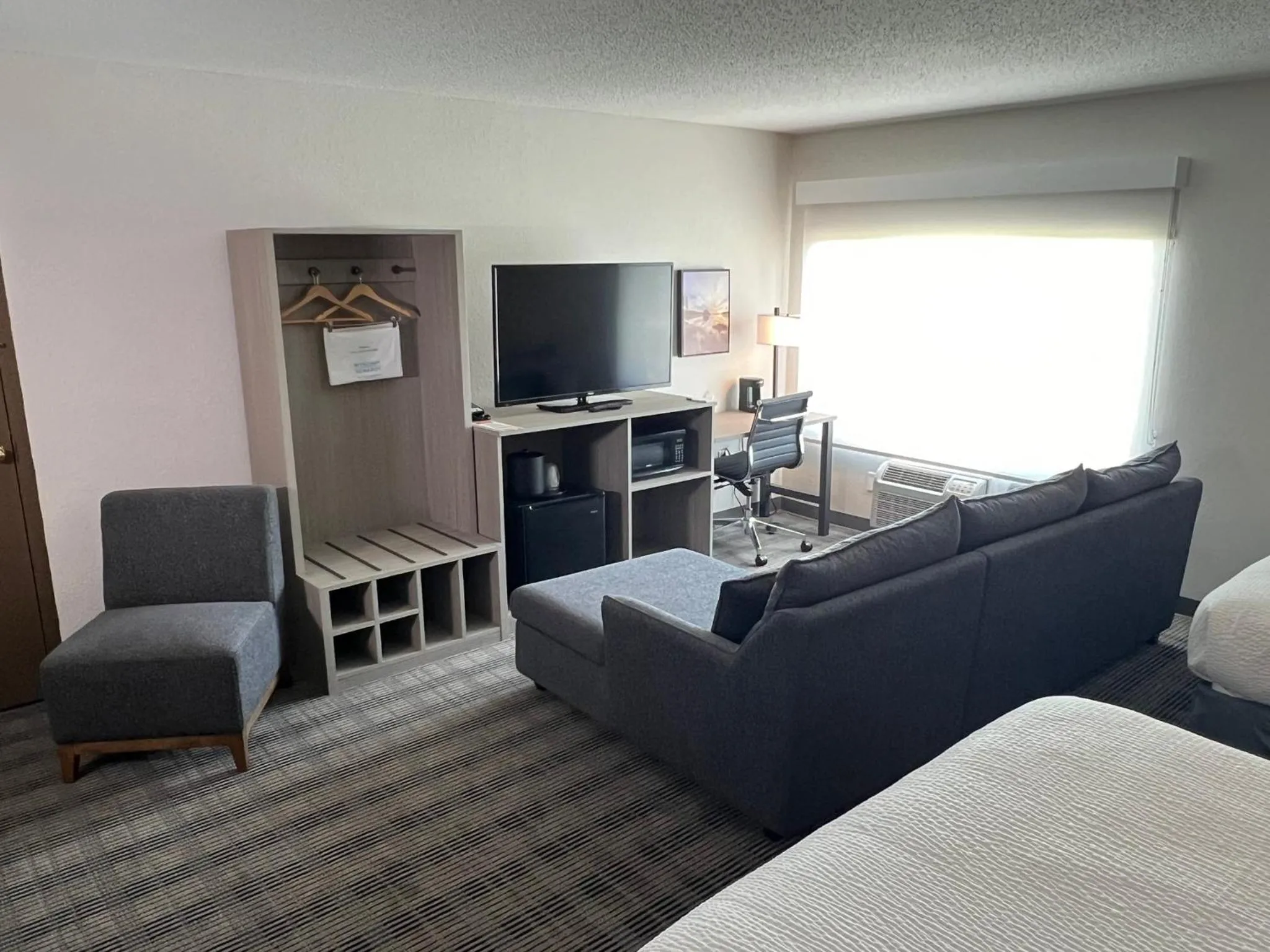 Communal lounge/ TV room, Bed in AmericInn by Wyndham Baxter Brainerd