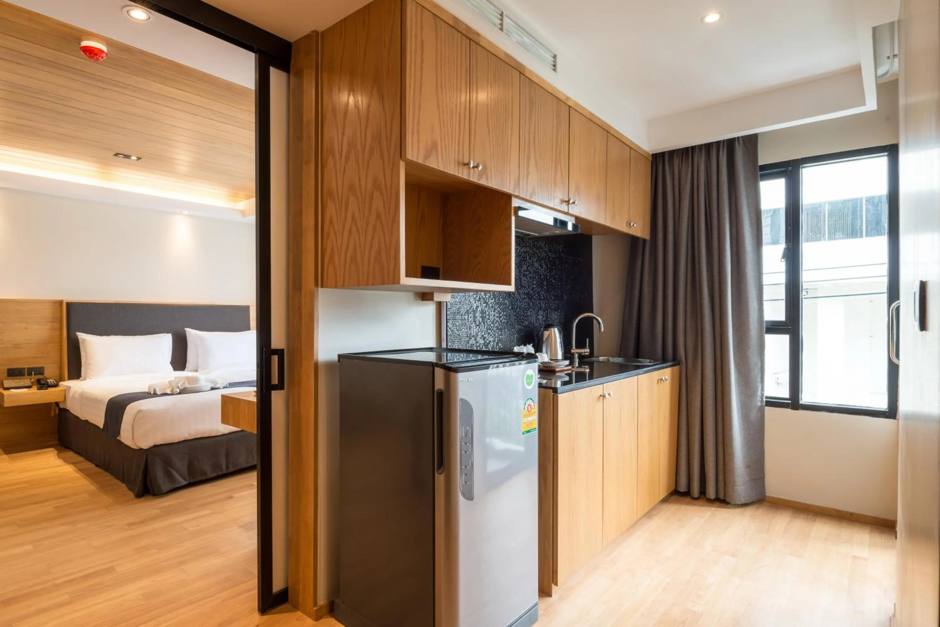 Kitchen or kitchenette, Bed in Asana Hotel & Residence