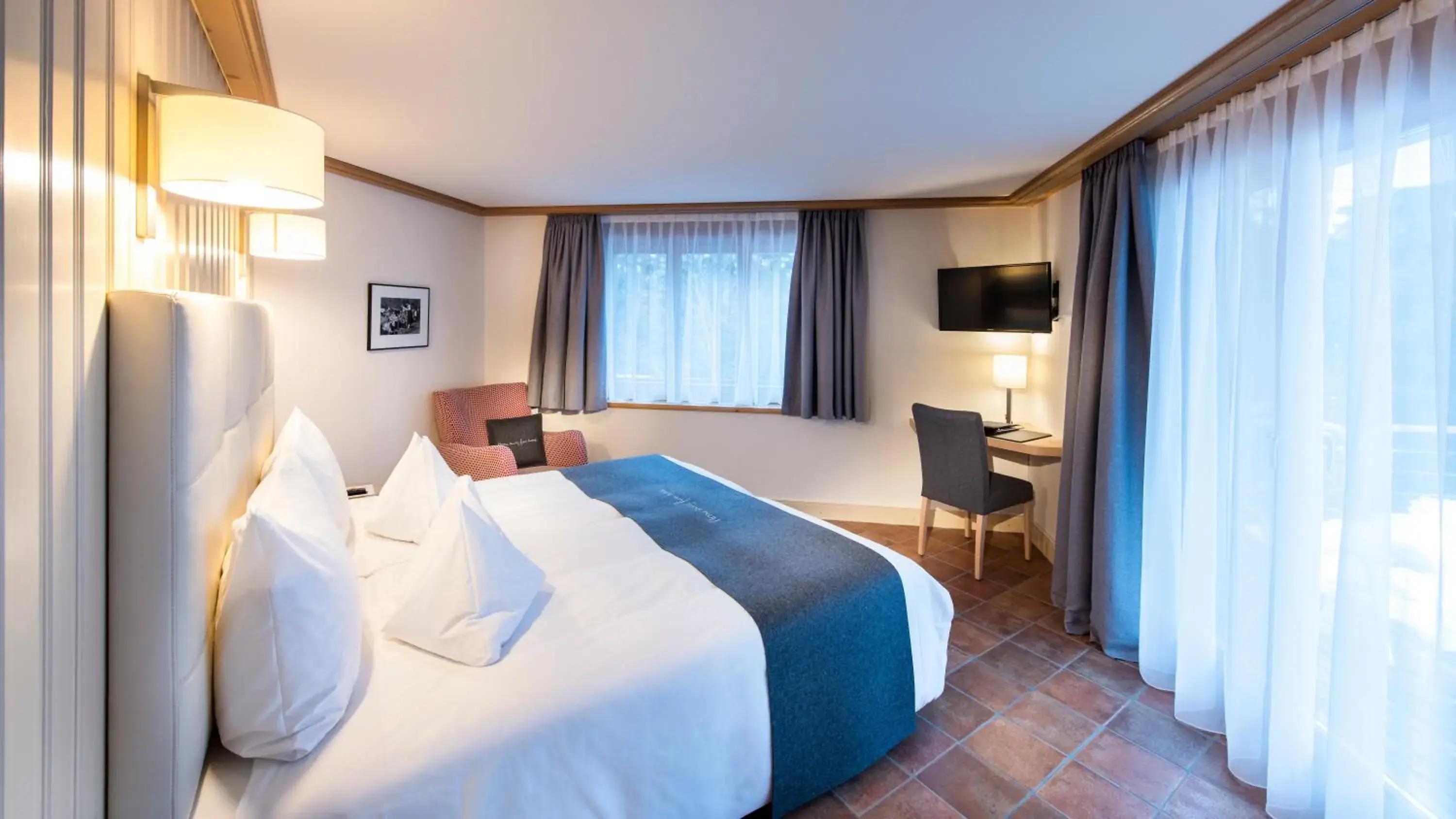 Photo of the whole room, Bed in GOLFHOTEL Les Hauts de Gstaad & SPA Photo of the whole room, Bed in GOLFHOTEL Les Hauts de Gstaad & SPA