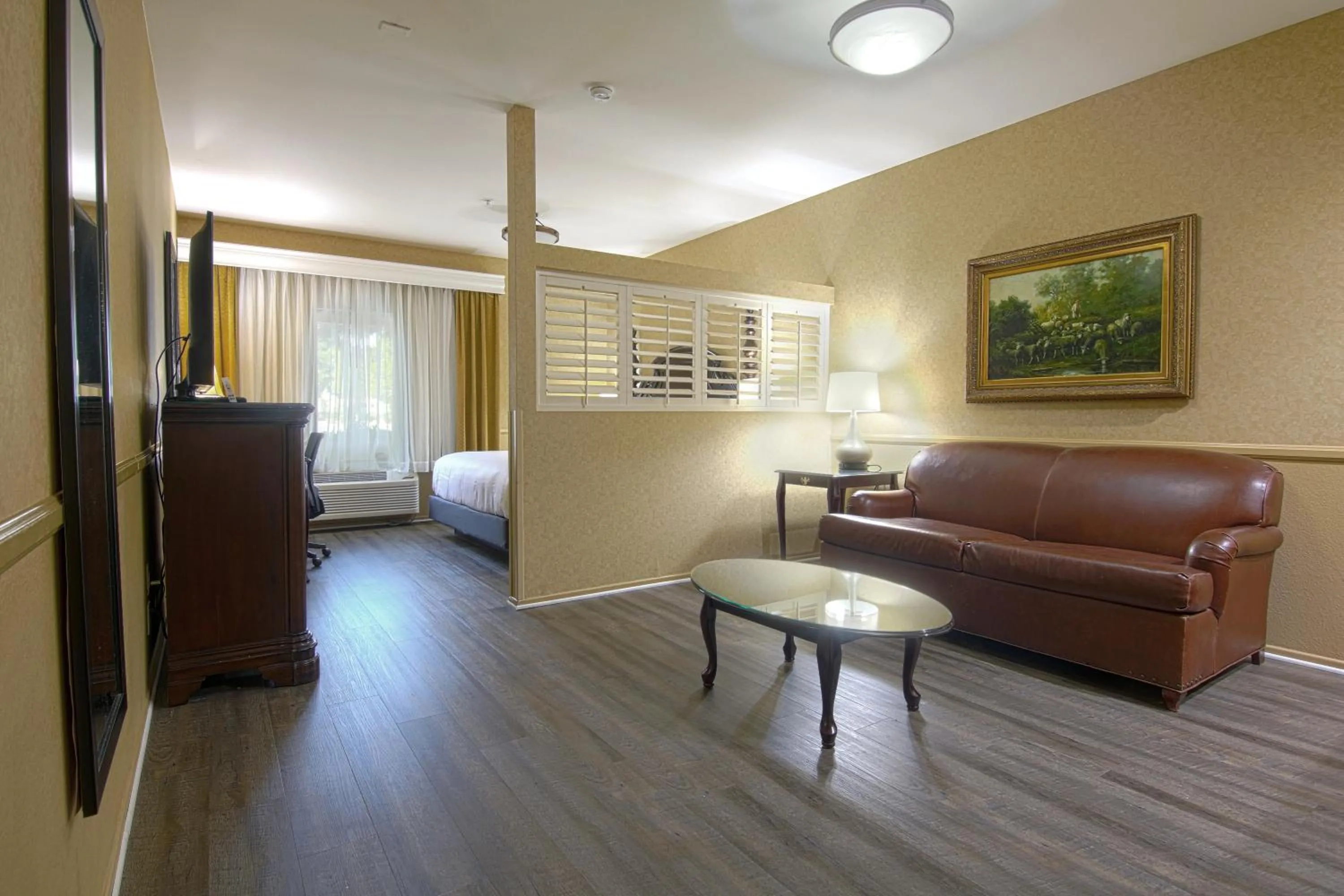 Seating area, Bed in Azure Hotel&Suites Ontario Trademark Collection by Wyndham