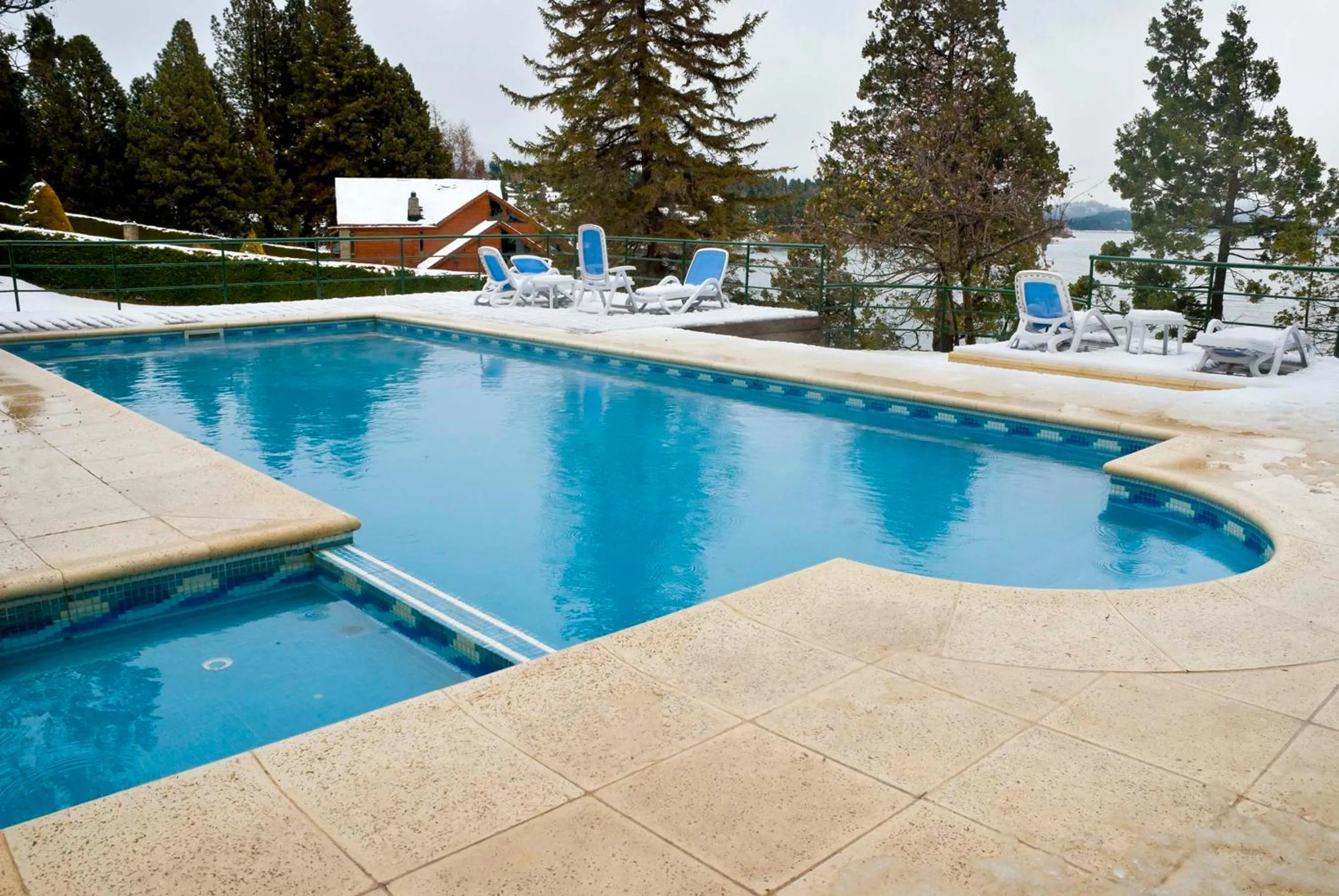 Swimming pool in Charming Luxury Lodge & Private Spa