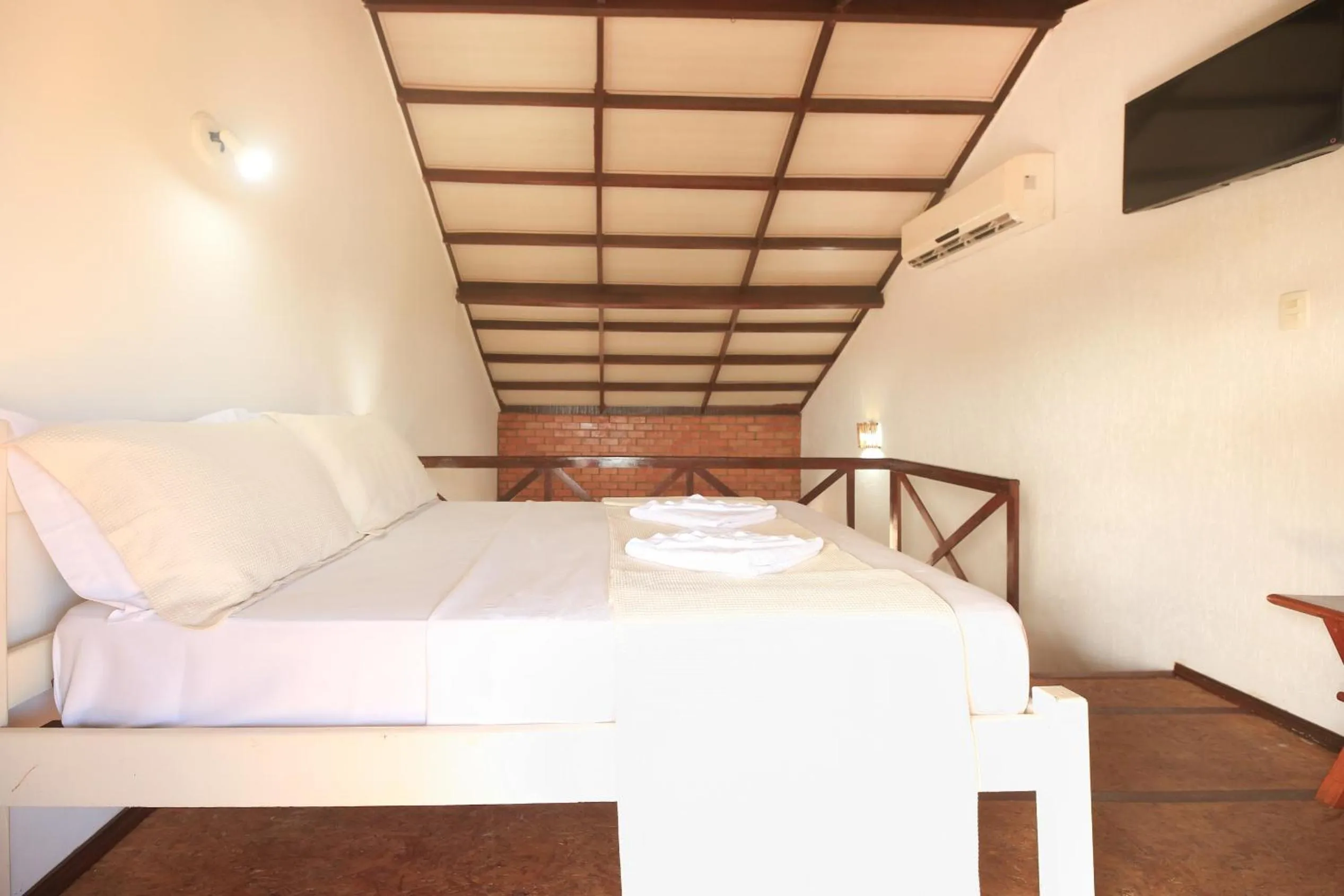 Bed in Pousada Bicho Preguiça