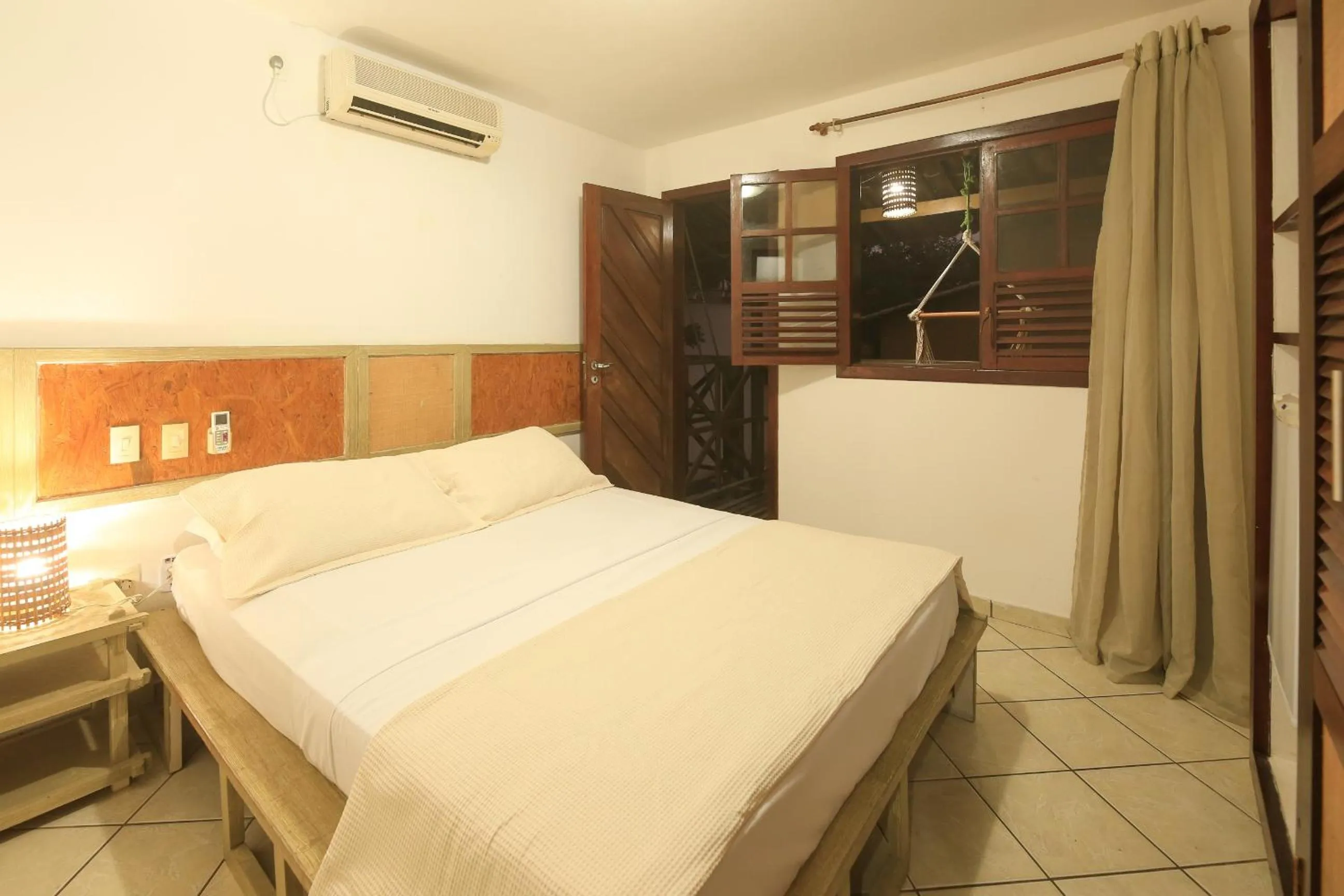 Bed in Pousada Bicho Preguiça