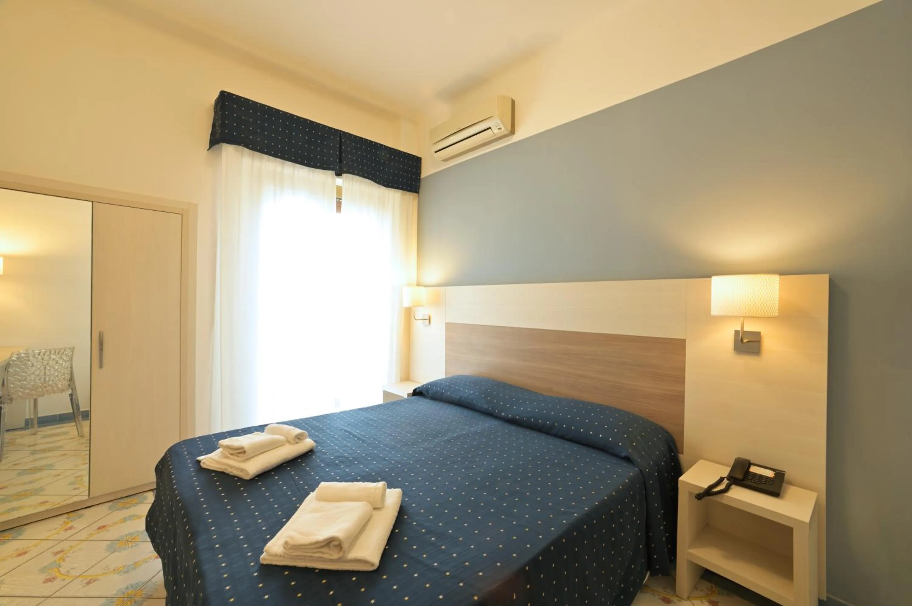 Bed in Hotel Delfino