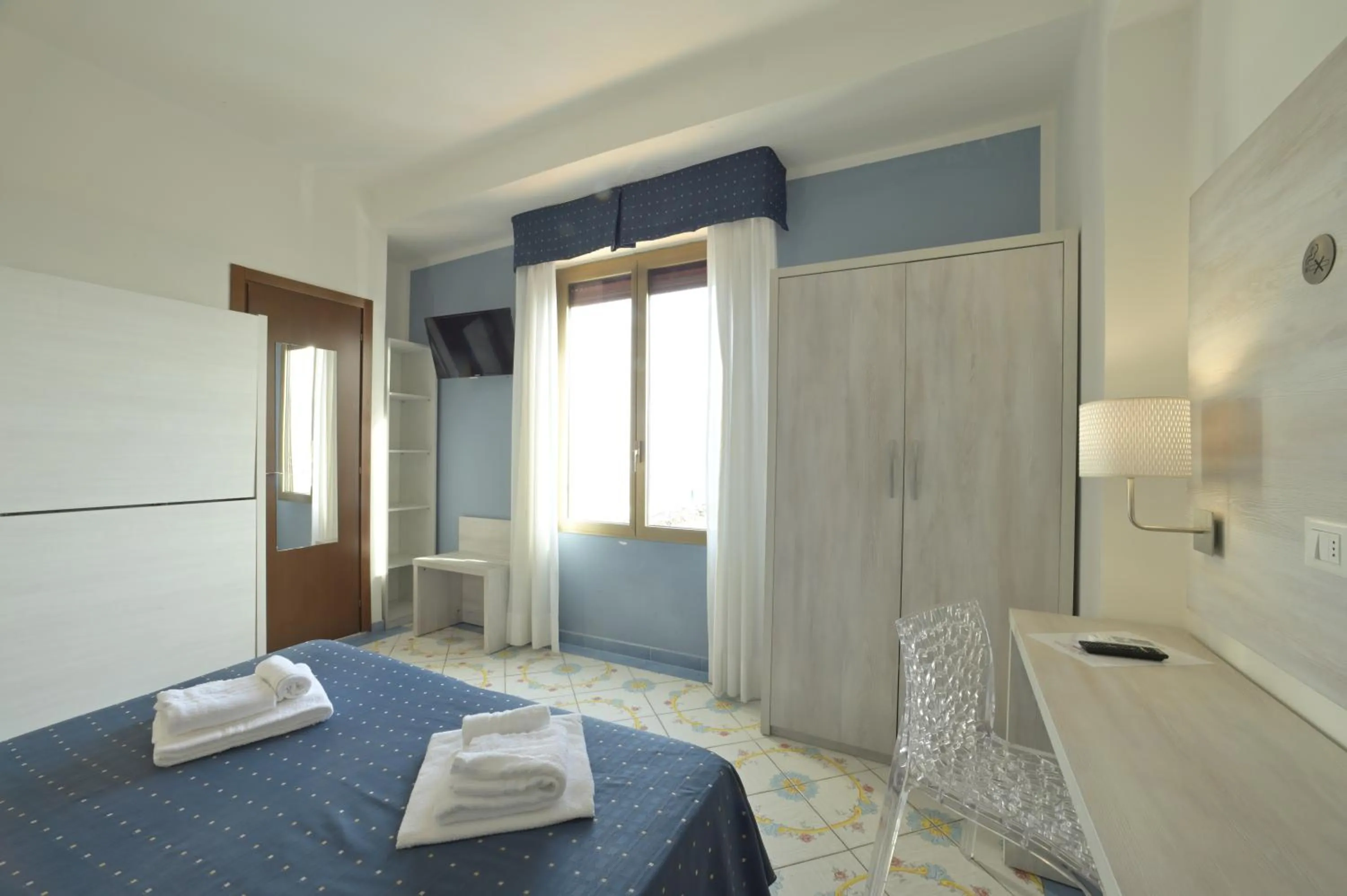 Bed in Hotel Delfino