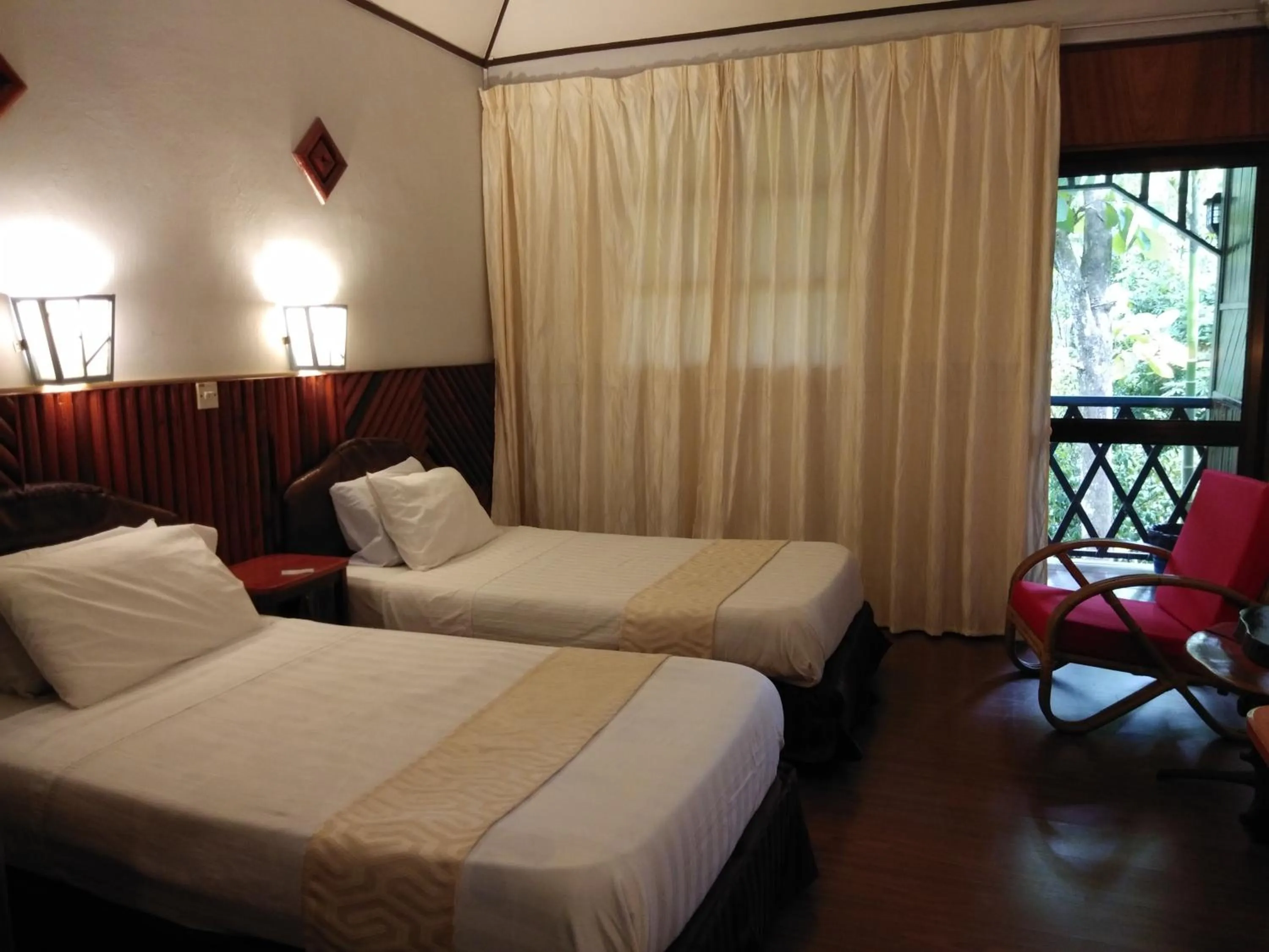 Bed in Sepilok Jungle Resort