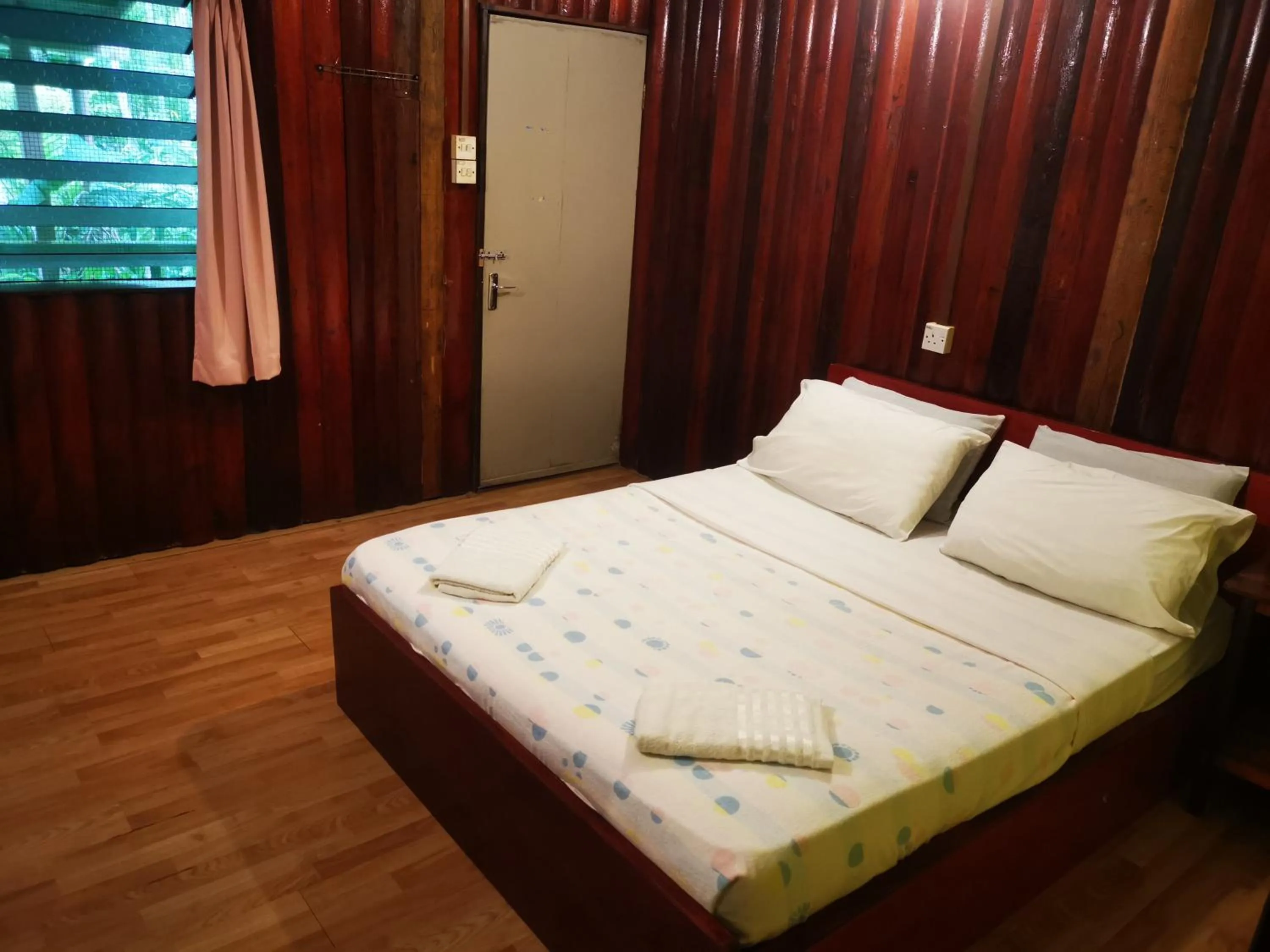 Bed in Sepilok Jungle Resort