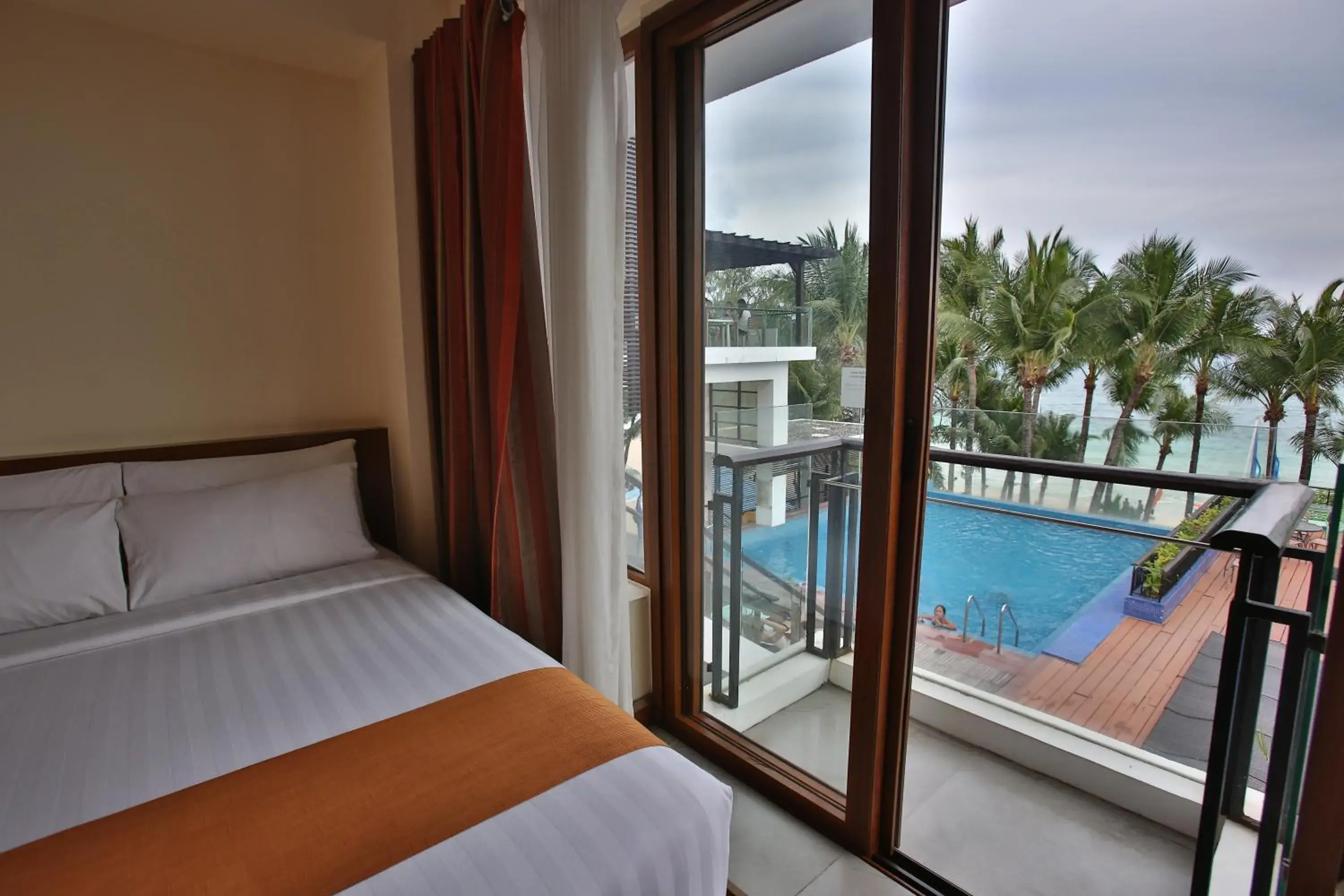 Balcony/Terrace, Bed in Crown Regency Beach Resort Balcony/Terrace, Bed in Crown Regency Beach Resort