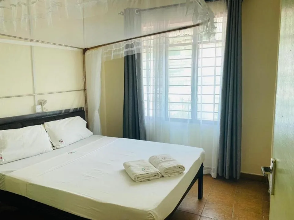 Bed in Merry Villa Hotel & Apartments