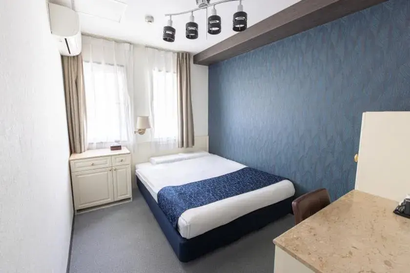 Bed in New Osaka Hotel Shinsaibashi Bed in New Osaka Hotel Shinsaibashi