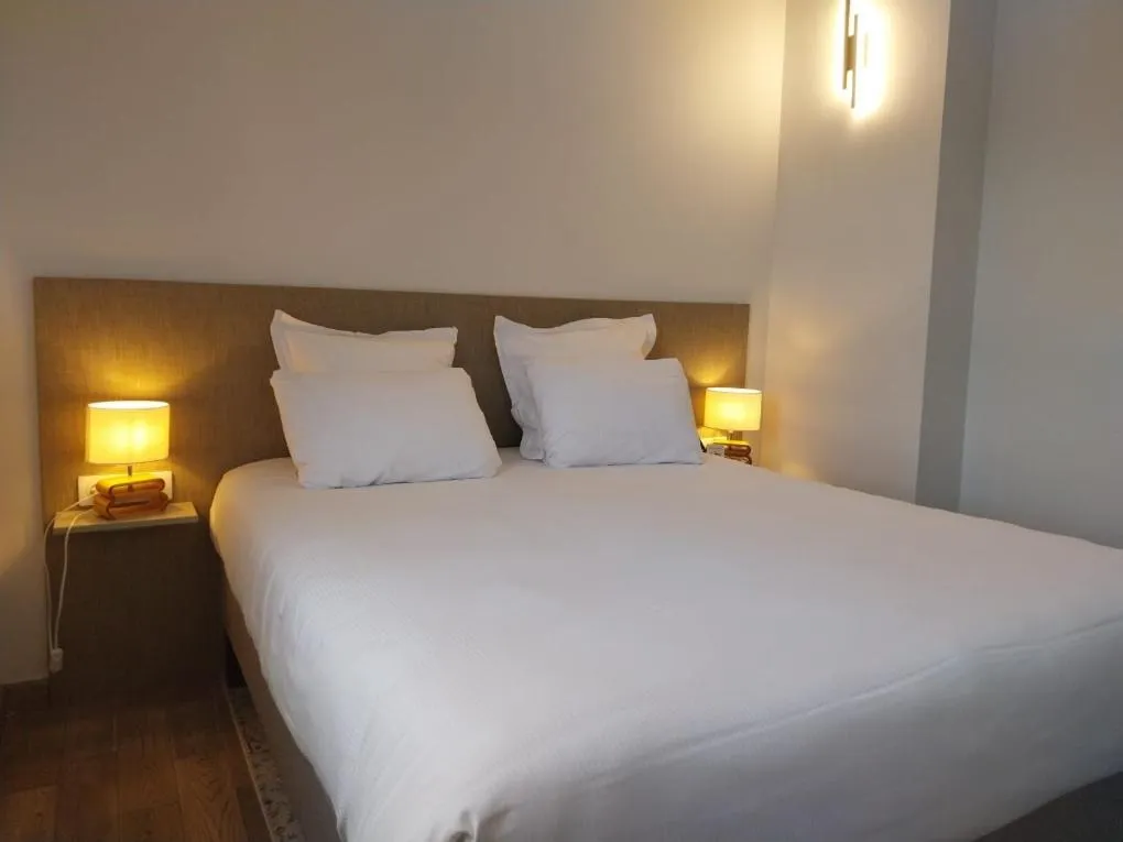 Bed in Logis Hôtel Saint Guirec Et De La Plage