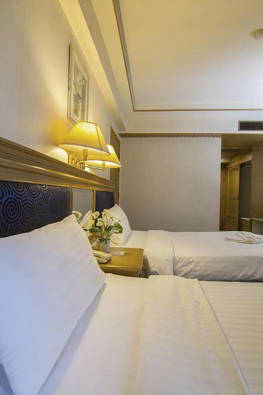 Bed in Bossotel Chiang Mai