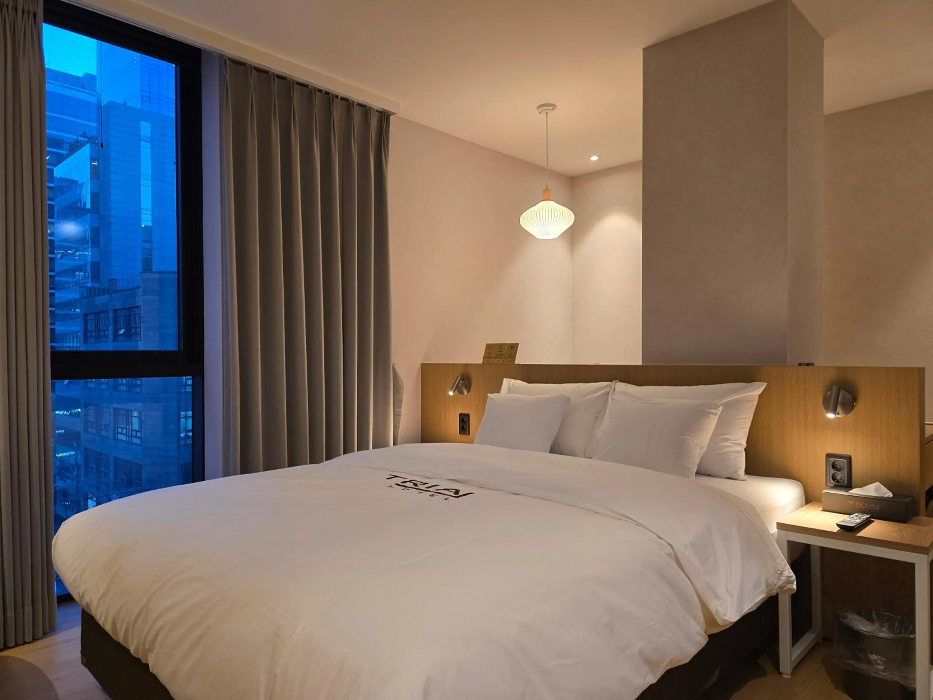 Bed in Tria Business & Boutique Hotel