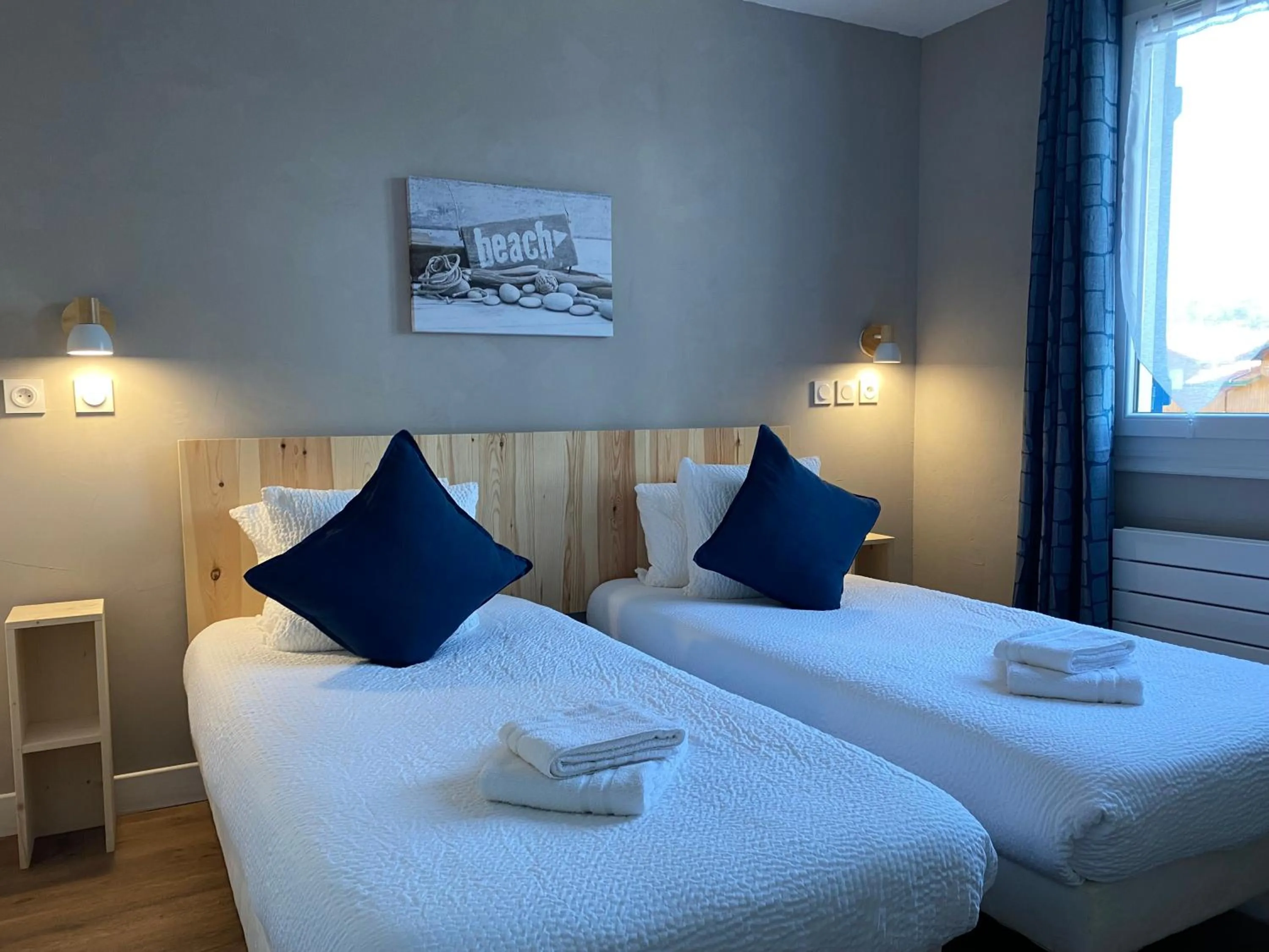 Bed in Logis Hôtel Emeraude des Bois