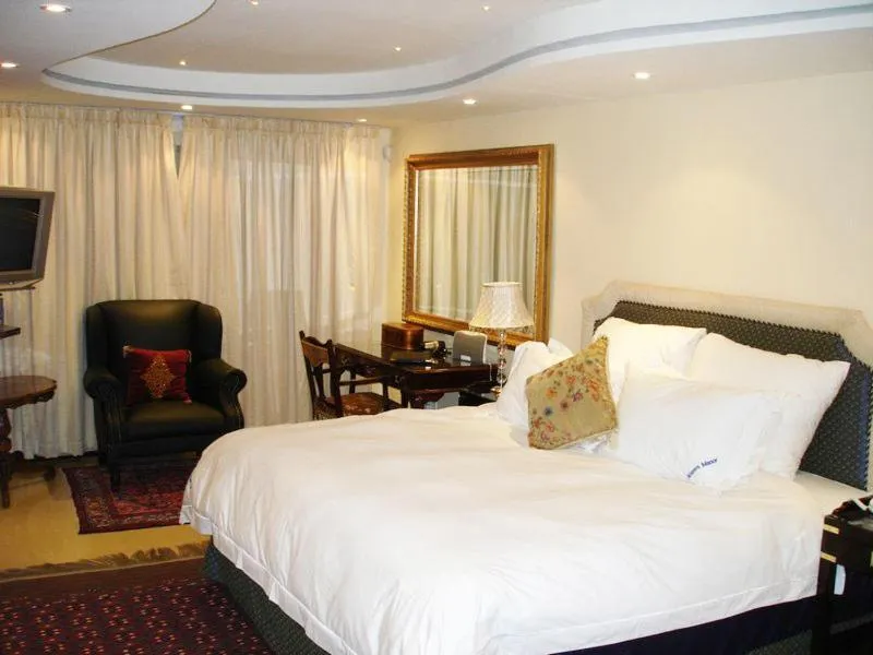 Bed in Kosmos Manor Guest House