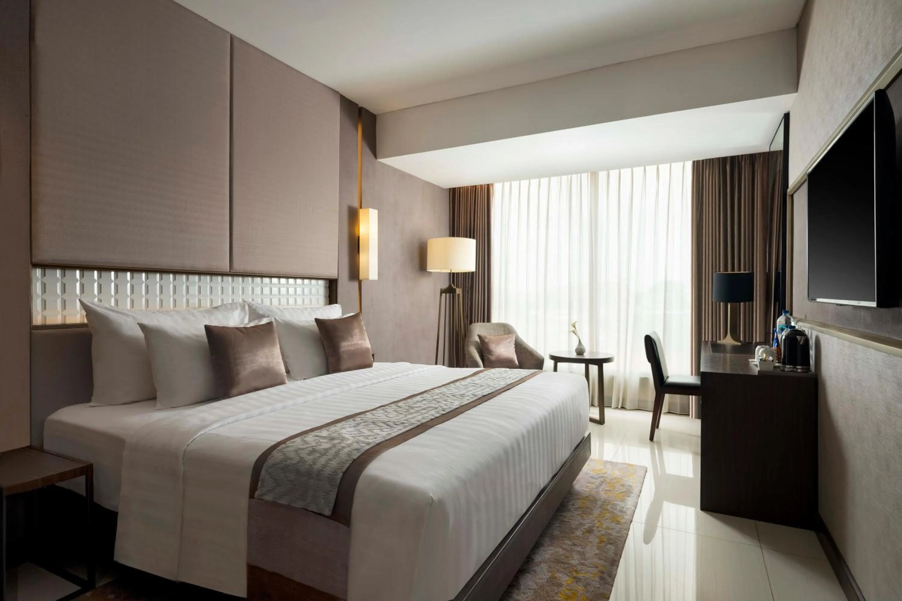 Bed in GRAMM HOTEL by Ambarrukmo Yogyakarta