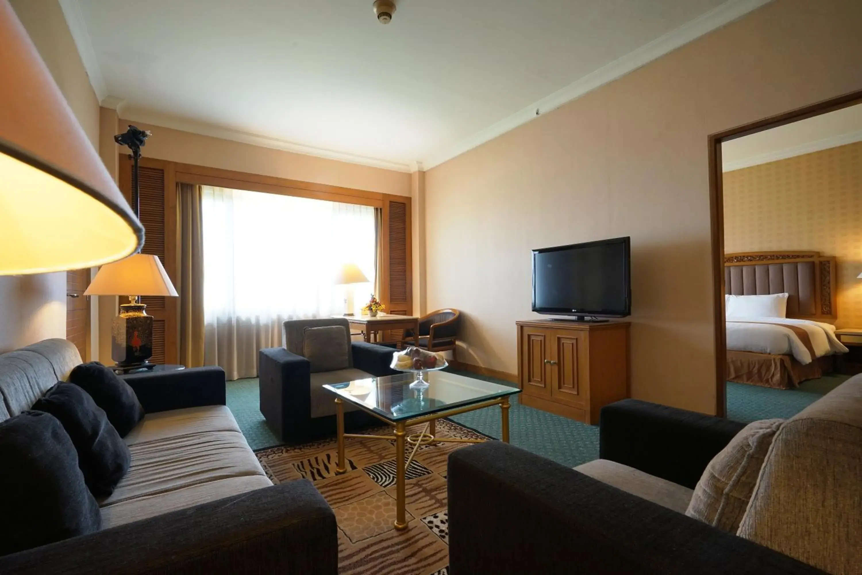 Living room, Bed in Grand Diamond Hotel Yogyakarta Living room, Bed in Grand Diamond Hotel Yogyakarta