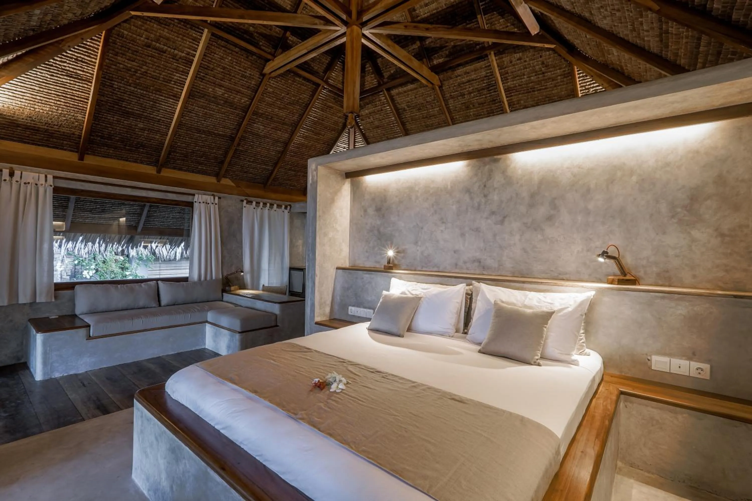Seating area, Bed in Coral Eye Boutique Resort and Marine Outpost