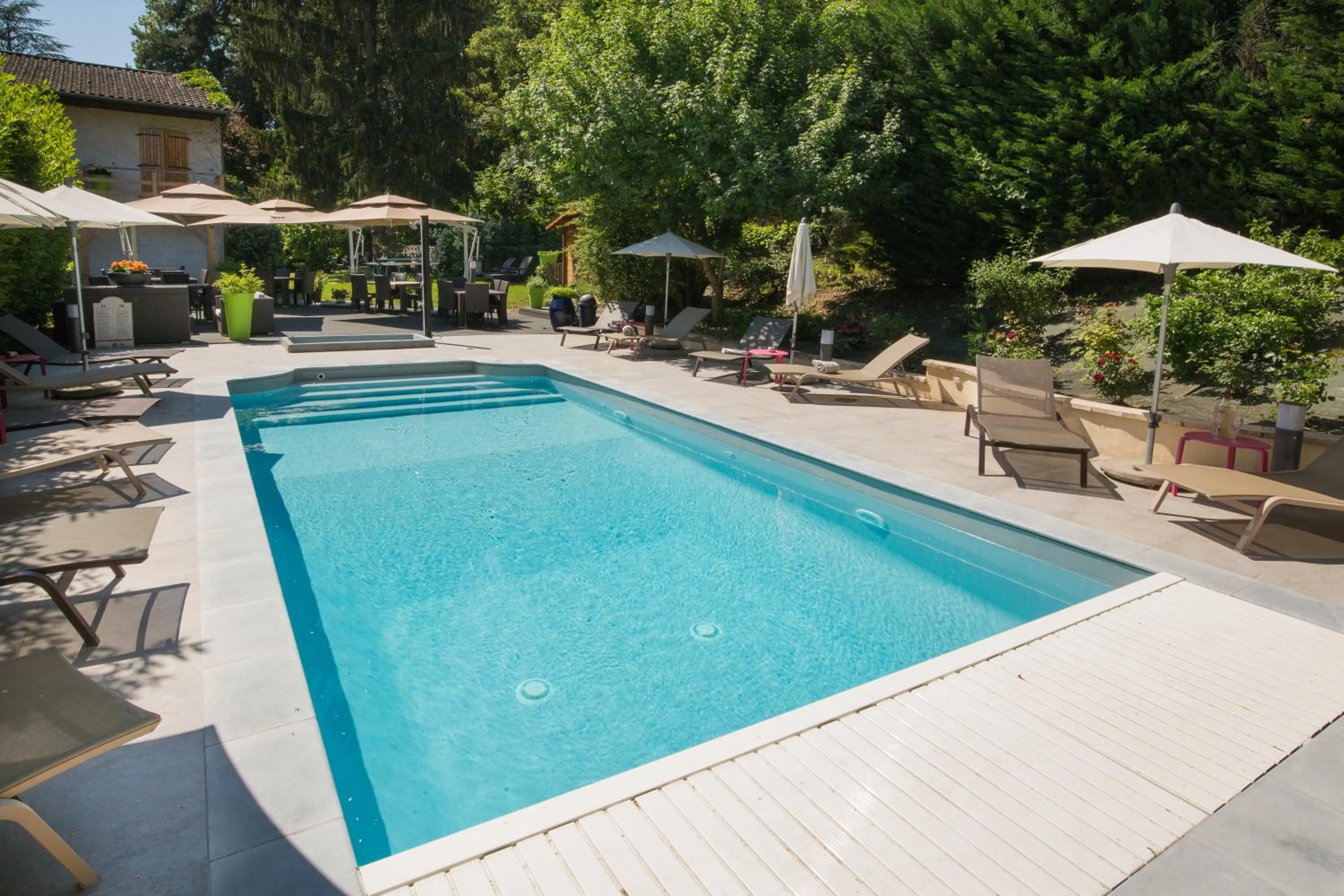 Swimming pool in Logis Hotel Le Petit Casset