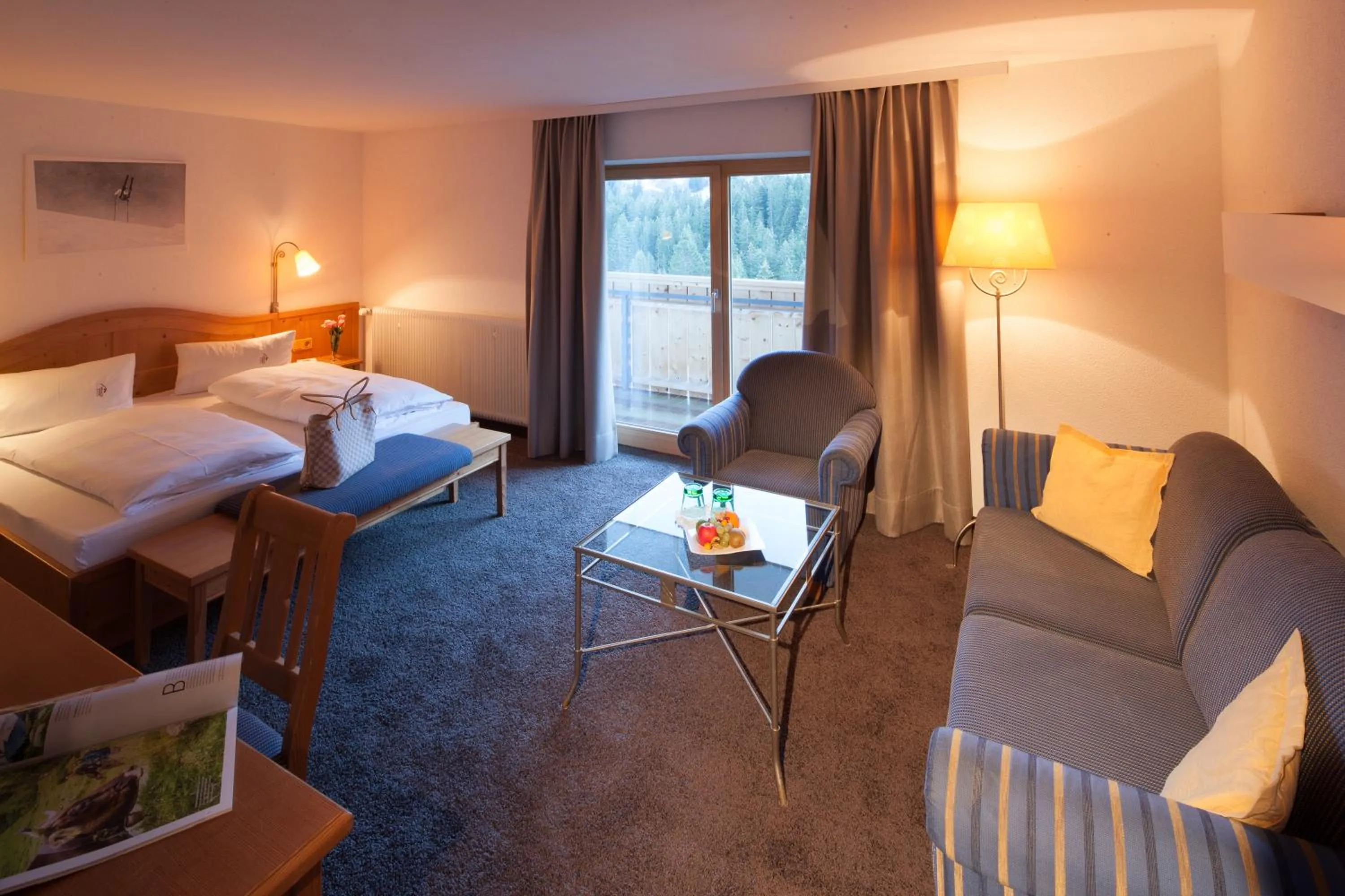 Seating area, Bed in Alpine Lifestyle Berghotel Madlener