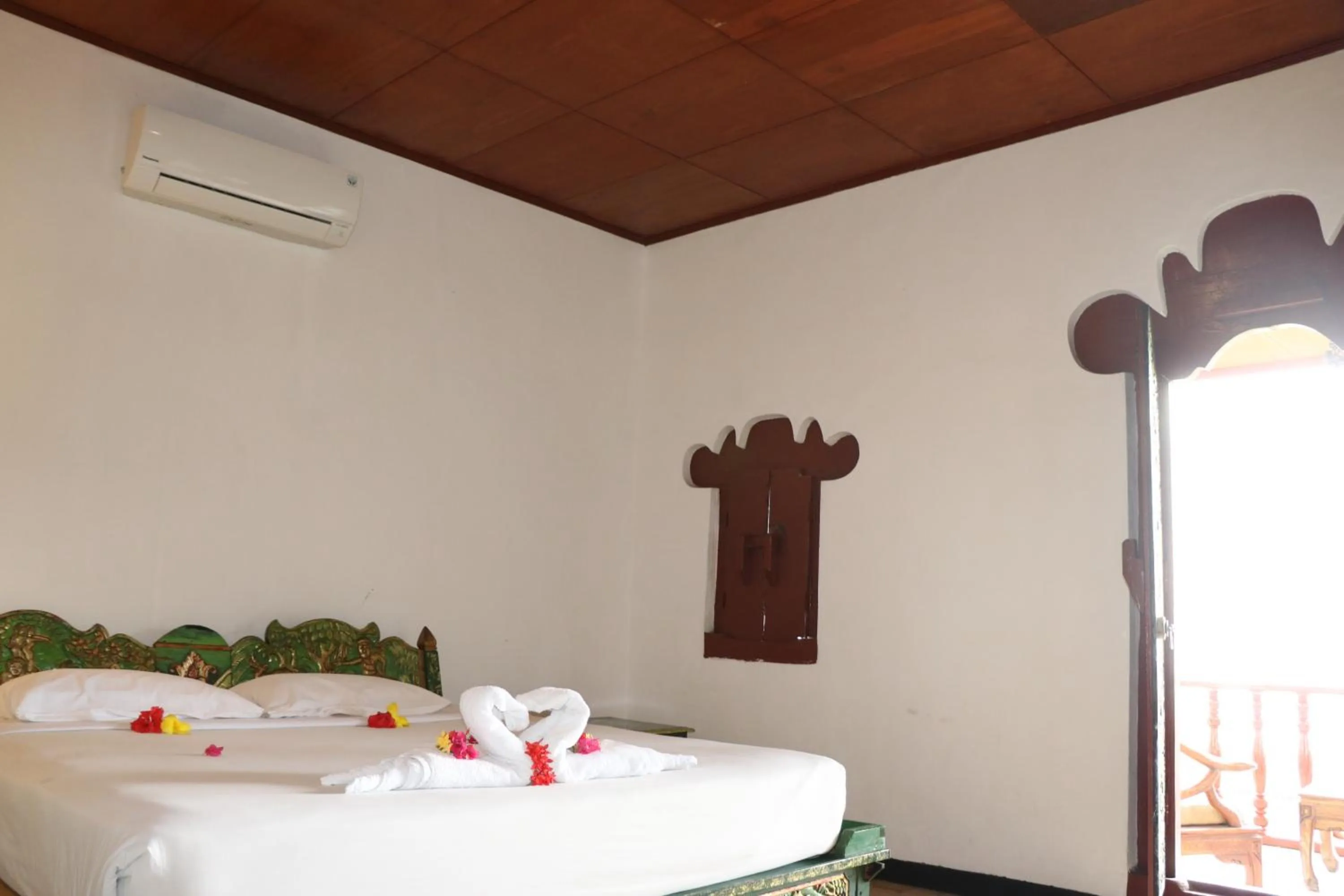 Bed in Puri Bunga Beach Cottages
