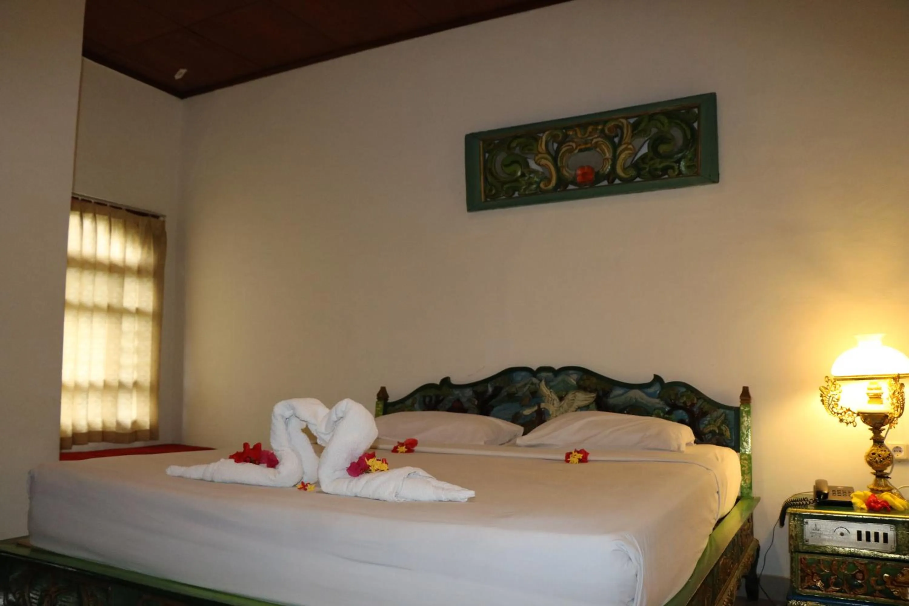 Bed in Puri Bunga Beach Cottages