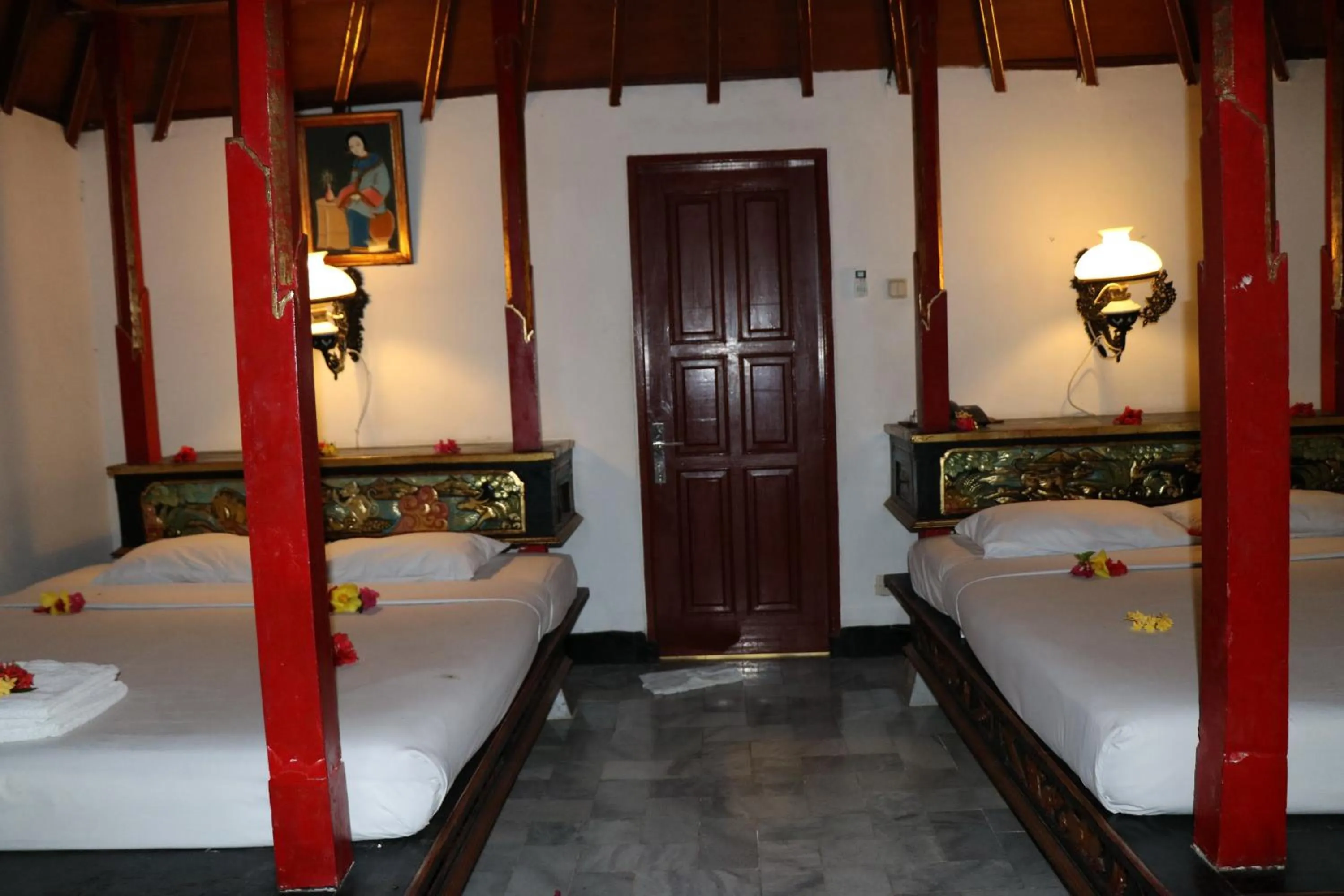 Bed in Puri Bunga Beach Cottages