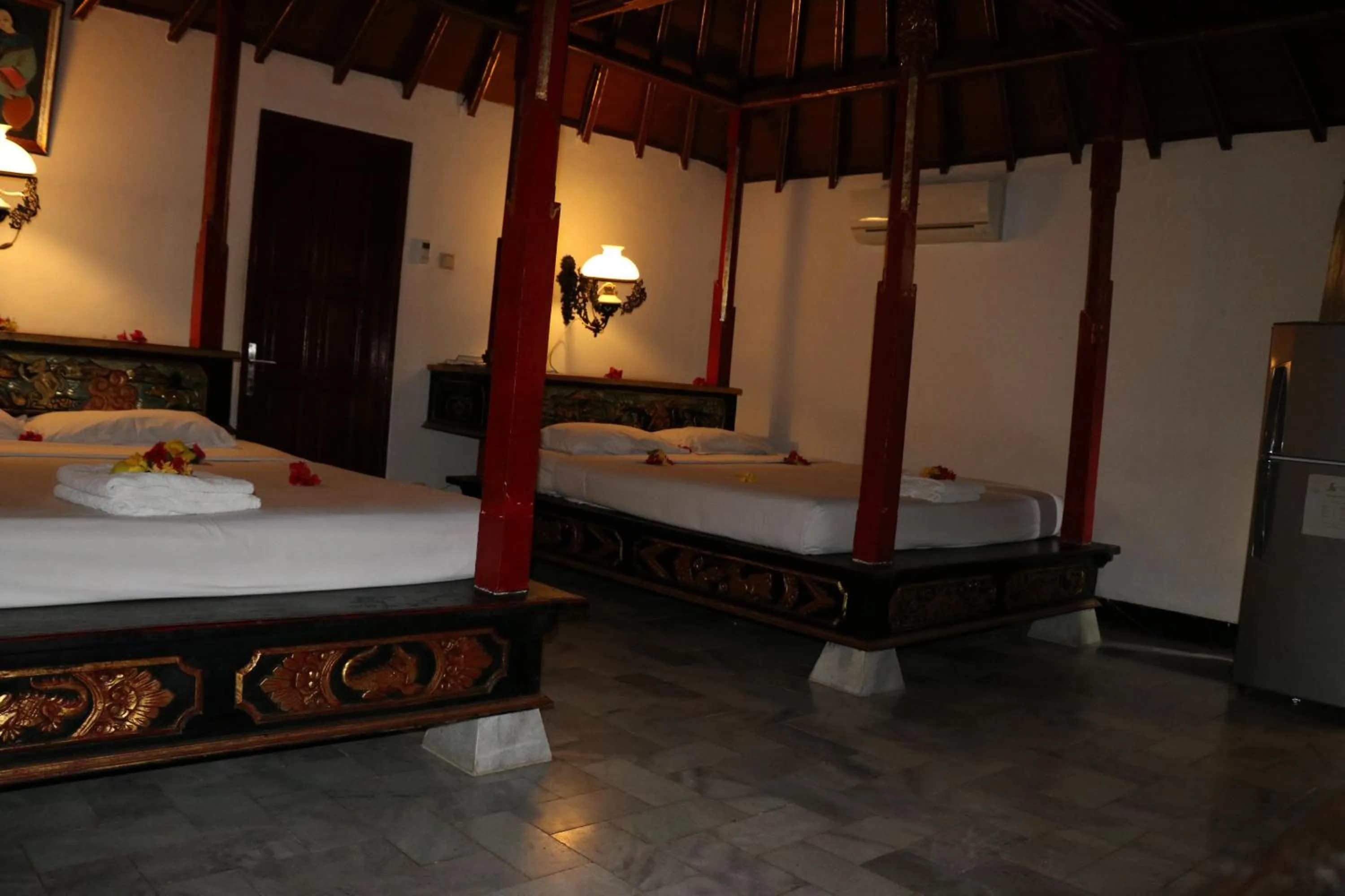 Bed in Puri Bunga Beach Cottages